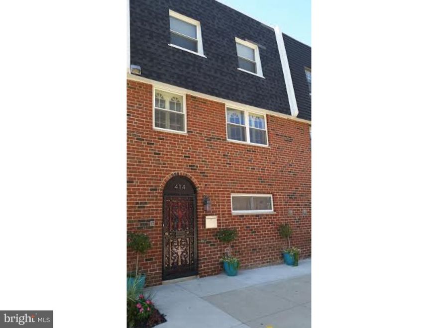 This large, three story townhome in South Philadelphia has four bedrooms, three full bathrooms, and two kitchens. When entering the ground floor, you walk into a spacious foyer and proceed to a lower level living area which can be used as an in-law suite apartment or additional living space. This area has a bedroom, full kitchen, and a living room that leads to an uncommonly large backyard and patio area.  Upon entering the second floor you are greeted with 12' ceilings, large windows and sunlit rooms of a split-level, open floor plan consisting of a living room, formal dining room and an eat-in-kitchen that features all stainless steel appliances, granite countertops, and Thomasville cabinets. The third floor contains a brand new large hall bathroom with an extra deep tub for those relaxing evenings, a master suite that has its own newly redone full bathroom and walk-in closet. There are also two ample sized additional bedrooms with closets and two hall linen closets. Hardwood floors are throughout the main living areas, stairs, bedrooms and halls with a parquet floor in the kitchen. This is a beautiful home. ***Public records shows the property at approximately 1440 square feet, this number does not seem to reflect the ground level square footage. This home is approximately 2000 square feet**