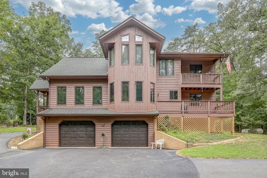 Don't miss this incredible opportunity to own this home in Windwood Coves at Lake Anna, situated within a gated community with High Speed Fiber Internet! This charming lake-access retreat includes your very own assigned deep-water boat slip (173) in the common area and is located in the most coveted subdivision at Lake Anna.  This 3 bedroom, 2.5 bath home is nestled on a .92 acre lot.  Step inside to the family room that features vaulted ceilings and a gas fireplace.  The spacious kitchen has a center island and is open to the dining area that has a bay window.  There are two main level bedrooms, a full bath and laundry room.  Upstairs, the primary suite has a walk-in closet, large soaking tub, separate tiled shower and a double vanity.  The primary suite also has its own private balcony: the perfect space for your morning coffee or a peaceful afternoon read.  Paved driveway, a two car built-in garage and there is also additional unfinished space in the basement that is perfect for storage or to finish as you wish.  The back yard is perfect for outdoor games and entertaining.  Beyond its natural beauty, the community offers a range of amenities to enhance your lifestyle, including spending your days boating, fishing, or simply soaking up the sun on the shores of the lake. Nestled in the sought after Windwood Coves Subdivision, a gated community on the lake with multiple common areas.  Great mid-lake location just minutes to groceries, dining, Lake Anna Taphouse and more!  Explore hours of fun at common area where you can launch your boat and enjoy the large sandy beach, picnic pavilion, playground, pickleball and tennis court.  Golf Cart friendly community!  Come see for yourself and start making your memories here with your family and friends!  Boat slip 173 is located in the Marshall Creek common area (See boat slip map in MLS Documents).  HVAC 2020 | Roof 2020| House Stained 2022