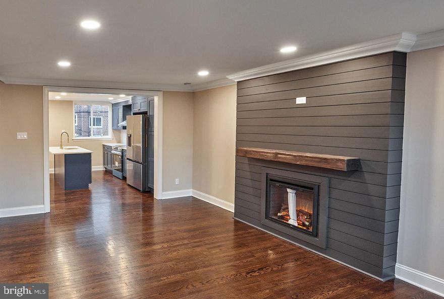 Welcome to this beautifully renovated 3BD / 1.5BA home featuring an open-concept kitchen with brand-new, state-of-the-art appliances, new baths, all-new plumbing, new windows, refinished espresso-stained hardwood floors, richly colored accent walls, crown moulding, a newer torch-down roof, central AC, finished basement & more—minutes from Chestnut Hill & Mt. Airy.

Enter a seamless open layout w/ hardwood floors, recessed lighting & crowns. The living room centers on a shiplap electric fireplace, with plenty of room for personal design. Through a molded archway, the kitchen offers a 76" island, Nova Blue cabinetry, quartz counters, Kraus pull-down faucet, brass hardware, white glazed ceramic backsplash & a dining area with batten board accent wall & a gold chandelier.

Upstairs: wide staircase, 3 spacious BRs w/ ample closets & a new bath w/ Spanish wood-look tile, gold accents & a floating 30" vanity. The finished basement includes hosting space, a molded accent wall for large TV & new powder room. Laundry w/ new W/D + newer WH. Large painted garage fits full-size vehicles.
