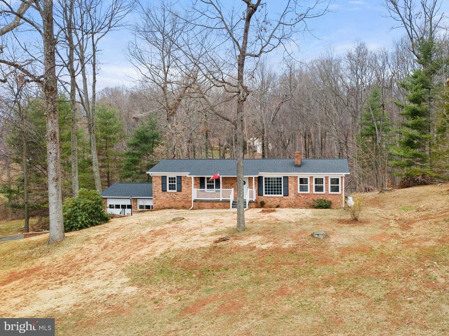 Available for the first time is this adorable brick rambler situated in a location convenient to all Fauquier has to offer.  This home features nearly 3000 sq. ft. of finished space including 3 br’s and 2.5 baths, living room and huge sunroom with tons of natural light on the main level.  Down the hall you will find a full bath as well as three bedrooms including the primary. Rounding  out the main level is a living room containing a cozy gas fireplace with a brick chase that easily could be converted back to a wood burner if so desired.  The propane heater in the sunroom also has a flu for a wood stove and could easily be converted.  In the basement you’ll find all new flooring, paint and electrical heating system.  The only thing needed is your imagination to figure out what to do with all that space! A potential fourth bedroom, home gym, office, craft room or whatever your needs may be; this space can fill them.  Outside, in the front, you will be pleased to find a covered front porch and sunrise as well as  mountain views that are offered.  In the back of the home you are afforded the ability to retreat to the wilderness.  From your deck watch the wildlife in the forest and listen to the birds sing as they move across your 1.92 acre lot. The oversized two-car garage with automatic door openers and pedestrian access from the back yard is large enough to park your vehicles and still have work space for the hobbyist.  This home offers a brand new roof and gutters, windows, HVAC system, well and pump, deck, water heater, paint, flooring, and landscaping all complimenting the home’s cozy country living.  Downtown Warrenton, Marshall, Haymarket and Gainesville are all within a 15 minute drive.  Great Meadow Fields Event Center is just a mile away. Enjoy equestrian events, Highland games and 4th of July celebrations just up the street.  I66 is less than 3 miles away; commuting is a breeze.  Let’s get you home to 5410 James Madison Highway in The Plains, VA