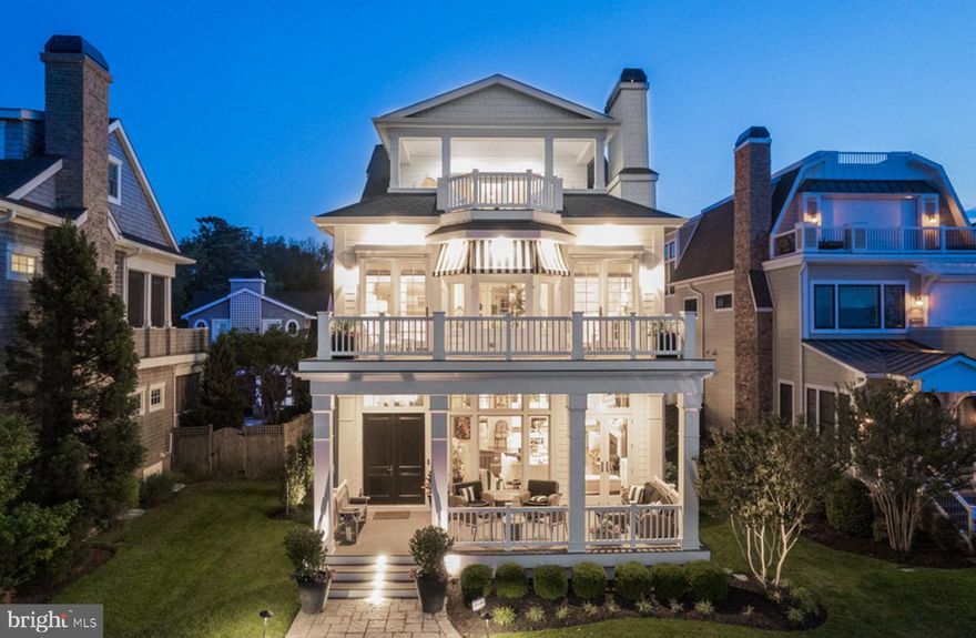 Welcome to 20418 Silver Lake Drive, a spectacular coastal retreat locally known as “High Pointe.” This striking 6 bedroom, 6.5 bath custom built home is perched on one of the most iconic locations in Rehoboth Beach along Silver Lake, offering breathtaking lake and ocean views. Shingle style siding, chic-striped awnings, lush landscaping and multiple levels of decks and porches create the most stunning front elevation. With over 4,600 square feet of living space, over 1,000 square feet of porches and decks, and an unfinished basement, this home has it all. Brisk ocean breezes are always enjoyable on the cozy and inviting front porch.  Upon entering “High Pointe,” you will be enticed by the timeless finishes tastefully accented with eclectic mix of artwork and appointments. Soaring 12-foot ceilings and dramatic marble floors decorate the foyer and lead you to a spacious open concept living area surrounded by floor-to-ceiling windows, coffered ceilings, and a beautiful gas fireplace. The living space neighbors the elegant dining area and overlooks a stunning chef’s kitchen complete with stainless appliances, 6-burner Viking cooktop, ice maker and beverage fridge. In addition, the first level is home to a cheerful first-floor bedroom suite, large laundry room that doubles as a butler’s pantry, an elegant powder room with grass cloth wallpaper, wainscotting and a whimsical chandelier, and a rear screened porch that overlooks the manicured private yard. Intricate moldings and oversized windows align the staircase that leads to the second level where you will find a gorgeous foyer complete with built-ins and personal library. This level boasts the waterfront primary suite complete with dual walk-in closets, laundry, sitting area and upscale ensuite bath, and access to a tranquil sundeck complete with surround sound and unobstructed Silver Lake views. In addition, there are two more guest bedrooms, complete with en-suite baths. The third level features more room for relaxation in the comfortable lounge that offers access to yet another sun deck offering spectacular lake and ocean views. Also, this level boasts the 5th bedroom complete with an ensuite bath, and a finished closet that doubles as a small office. Each level is easily accessible by an elevator for the utmost convenience, including the full unfinished basement, which offers the potential for more finished space. The grounds and outdoor living spaces at High Pointe are truly exquisite. As you step into the picturesque back yard, you will be surrounded by beautiful landscaping complete with irrigation, an expansive paver patio, heated, saltwater pool and outdoor shower draped in Wisteria. The landscape lighting, surround sound, and pool fountains are sure to set the tone for the most sophisticated summer soiree. In addition, High Pointe offers an oversized 2-car garage complete with a one bedroom, one bath guest apartment with full kitchen, living area and laundry closet. This home is being offered completely furnished, which allows the lucky new owner the opportunity for enjoyment during the 2022 summer season.
