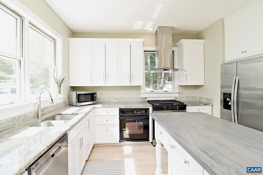 Move-in Ready! This one-of-a-kind, must see 3 bedroom, 3 bath W. Albemarle home is set on 8 acres of wooded privacy on Lickinghole Creek. Convenient to downtown Crozet, wineries, breweries, Chiles Peach Orchard, Crozet Park, and commuter routes. Located under 18 miles from UVA, and 20 minutes from the Blue Ridge Parkway. Enjoy the large side deck, screened-in porch, and garden space.  The light-filled 2,784 sqft home features refinished hardwood floors, abundant windows, a 1st-floor bedroom, a laundry room with a full-size washer and dryer, and a detached 2-car garage.  The main level includes an open living room with a stone fireplace, a dining area, a beautiful sunny kitchen with granite counters, newly installed and refinished cabinets, stainless steel appliances, and a built-in desk. A large bedroom, a full bath, and a laundry room are located down the hall.  The top level includes a primary bedroom with a private deck, a walk-in closet, and an updated ensuite bathroom with quartz vanity tops. A large family room/study includes a ventless gas fireplace and built-ins. An additional bedroom, a full bath, and a home office/guest bedroom are also on this level.  Up to two pets (25lbs max, per pet) are allowed with fees.