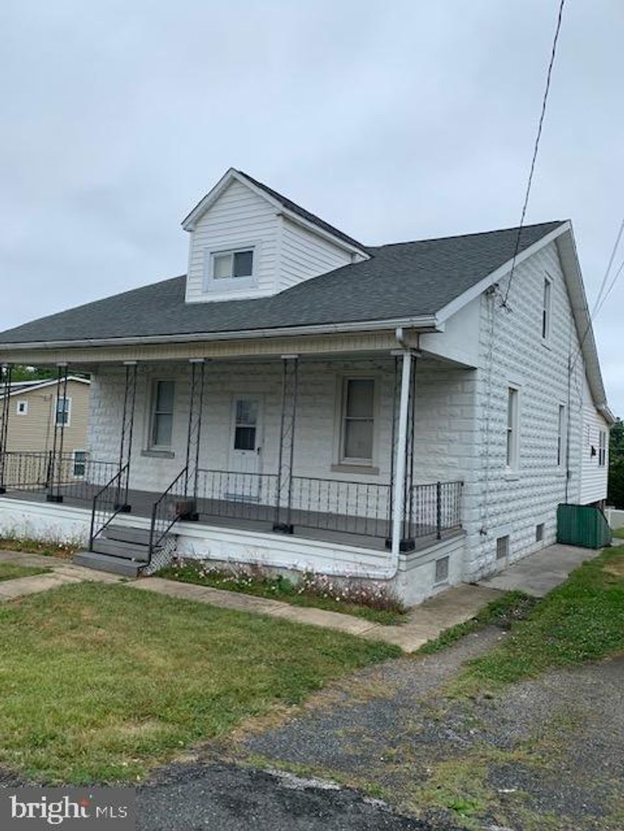 Detached & spacious home, foyer with nostalgic staircase to upper level. Home was previously set up with an apartment upstairs. Kitchen has been removed but plumbing is still in the walls. Private entrance through foyer to 1st and 2nd floors. Very large room sizes, transom windows between rooms, Hardwood floors visible in most rooms, HW likely under carpet and vinyl, Walk in closets in some bedrooms, Short hallway off kitchen offers closet space and leads to bathroom and bonus room which could be Breakfast Room, Den/Office, Playroom or Craft/Sewing Room. House has some paneled walls, wallpaper, plaster and drywall. Radiant heat with radiators in most rooms. Most replacement double hung windows, some with storms. All personal property, blinds and curtains included. Front and back storm doors, interior doors are historic 5 panel. Basement is unfinished but has double cast iron laundry sink and washer connections. An exterior door to side is covered outside. Rear deck is 8' x 6' and leads to sprawling back yard. Left side lot boundaries are believed to be marked by old chain link fence posts, driveway on left side is near property line. Right side of house has another long driveway with a slab at the rear that used to be the base for the garage before it was removed. On the front is a 30' x 8' composite covered porch, perfect for watching the world go by. All personal property in home is to be included. This will be a great house once it's rehabbed and updated!