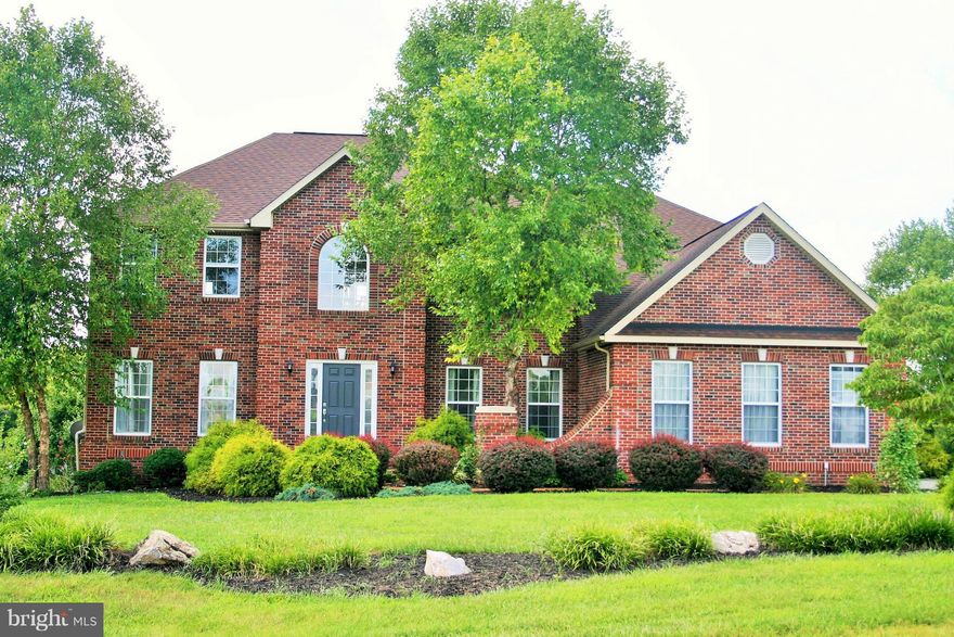 Large Brick front Colonial on 1.35 acre lot & no thru traffic.Flooring is tile,HWD & new carpet.Gourmet KIT, w/granite tops,island,recessed lighting & brkfst bar.Sun rm has acess to large trex deck w/pergola.Main level FR & w/FP,fan & crown molding. Ceilings are 9',2-story,vaulted & tray.2 MBRs one w/dual sided FP,WIC,dble vanity,whirlpool & sep shower.3-car side load garage & unfin WO bsmt .