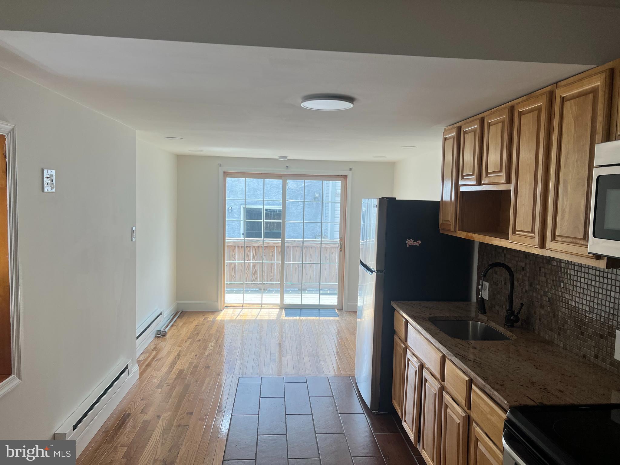 Located in the heart of Newbold, this sunny and spacious 1-bedroom, 1-bath apartment offers the perfect blend of charm and convenience. Situated on the second floor, the unit features gleaming hardwood floors, an open layout, and an abundance of natural light throughout.
Enjoy the comfort of in-unit laundry, a generously sized living area, and a private deck—ideal for your morning coffee or winding down at sunset. The kitchen flows effortlessly into the main living space, making entertaining a breeze.
Steps from Broad Street and just minutes to Center City, public transit, restaurants, and local shops, this home is a true South Philly gem.
1 Bed / 1 Bath * Hardwood floors * Washer & Dryer in-unit * Private deck * Lots of natural light * Prime Newbold location Available now—schedule your tour today!