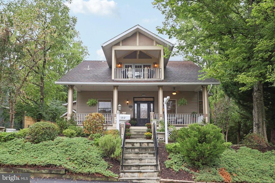 1212 N. Cleveland Street combines top-rated schools, exceptional parking, and a rare in-home elevator—all in the heart of Clarendon. Zoned for Arlington Science Focus Elementary, Dorothy Hamm Middle, and Washington-Liberty High, the home is ideally situated just steps from shops, restaurants, coffee, and Metro, yet enjoys the quiet charm of a tree-lined residential street. An attached two-car garage, driveway, and rear alley access together accommodate up to eight vehicles—an almost unheard-of convenience in such a highly walkable neighborhood. And with an elevator serving all three levels, the home offers comfort and accessibility for every stage of life.

Offering 6 bedrooms and 5 full baths across three finished levels, the home itself is as versatile as it is inviting. A wide front porch sets the tone, large enough to sit and enjoy a morning coffee or evening conversation, and opens to a foyer with warm hardwoods and detailed millwork. On the main level, formal and informal living spaces flow easily, from a den and living room to a dramatic family room with coffered ceiling, fireplace, and deck access. The kitchen is filled with natural light from skylights and cathedral ceilings, while an adjoining sunroom with its own gas stove creates a cheerful everyday hub that’s equally perfect for cozy winter afternoons or relaxed summer mornings. A main-level bedroom and full bath add flexibility for guests, home office needs, or multigenerational living.

Upstairs, the primary suite offers two walk-in closets and a spacious bath, joined by two additional bedrooms and two more full baths. The front bedroom feels like a second primary, featuring its own ensuite bath and a private balcony overlooking the tree-lined street. A dedicated laundry room on this level adds everyday convenience.

The walk-out lower level functions as a fully independent residence, complete with its own kitchen, living space, two bedrooms, bath, laundry, and private entrances. A fireplace anchors the main living area here, giving the space warmth and character and making it ideal for in-laws, long-term guests, or a rental opportunity.

Outdoor spaces are just as thoughtful, with multiple decks, a slate patio, and a lush private lot complete with a fig tree, a mature Redbud, and a show-stopping Magnolia tree that puts on a spectacular display each spring. These seasonal blooms can be enjoyed from the family room and deck, creating a serene and colorful backdrop.

Clarendon remains one of Arlington’s most vibrant and beloved neighborhoods, blending walkability, convenience, and community. With its ideal location, generous parking, excellent schools, elevator access, and timeless design, 1212 N. Cleveland Street offers a lifestyle that is truly unmatched.