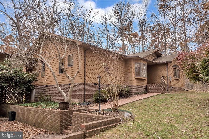 If you are seeking privacy, outdoor spaces, and a huge "bonus" room with full bath for man-caving, quilting, crafting, or as a teenage hangout,  you'll fall in love with one level living at 206 Edgemont Lane! Located on a cul-de-sac and taking  full advantage of this lot's setting, coffee on the deck watching the deer roam through the woods can be your morning ritual. And there's more: covered breezeway from the home to the bonus room above garage offering an expansive space for relaxing out of the sun, gazebo with another deck, and covered as well as secure storage, and oversized garage. This property offers almost a half acre in amenity-rich Lake of the Woods, where you can take a dip in the pool, jump in the lake, trail ride from the Equestrian Center, play a round of golf, play a game of tennis or pickle ball, work out at the fitness center, or enjoy a fabulous brunch at the Clubhouse overlooking the lake! Let's get this lake life started!