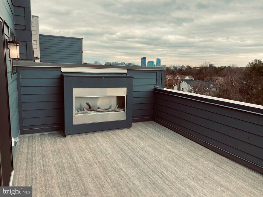 Luxury Living in this gorgeous 4BR, 4.5BA, 2-car garage townhome in one of Reston’s hottest new metro communities*Main level features bedroom/ office and full bath, neutral paint tones, recessed lighting & 2 car garage acccess. The spacious second level has lots of natural sunlight throughout an open floorplan*Contemporary kitchen is stunning with ample white cabinetry & hardware, quartz counters with complimentary designer tiled backsplash, stainless steel appliances & oversized island with pendant lighting*Open dining area with beautiful lighting fixture leads to spacious living room with  modern fireplace*The third upper level features large primary bedroom, walk in closet with custom built-in shelving & spa-like ensuite full bathroom featuring tiled floors & floor to ceiling frameless shower*Second bedroom and third nicely sized bedrooms with updated bathroom*laundry area with front load washer and dryer* 4th level with additional spacious bedroom, full bath & recreation room  accompanied by a  wet bar and fridge & sliding glass doors leading to private rooftop terrace with a second fireplace* This new neighborhood will also feature great amenities such as a children's playground, dog walking area & beautiful open green spaces*Located just steps to Silver Line Metro Herndon-Reston East Station* Close to new shopping, Whole Foods, Reston Town Center Shops & Restaurants + the ever-popular W&OD Trail*Conveniently located just a 10-minute drive from Dulles Washington Airport*Easy access to Main roads for commuters including Dulles Toll Rd, Rt 7 & Rt 28*