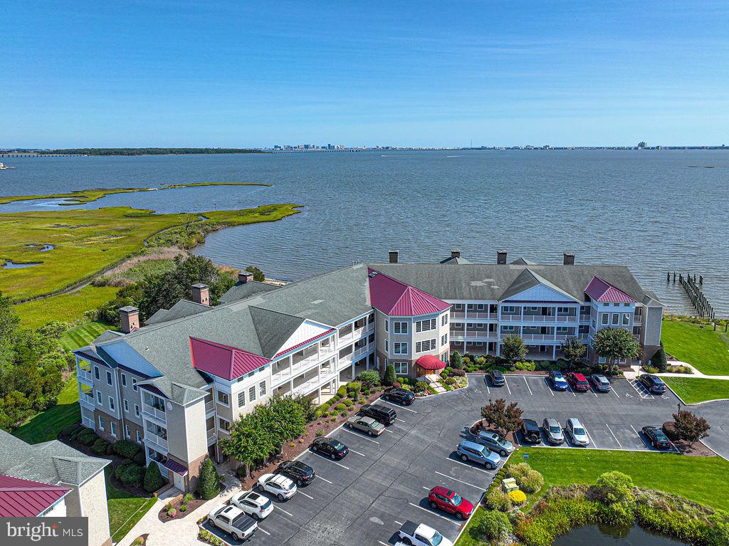 Sophisticated Bayfront Elegance in Ocean Pines. Step into a peaceful waterfront retreat where comfort meets coastal charm. This beautifully maintained bayfront condo offers stunning water views during the day and a beautiful display of lights reflecting across the bay at night—your own relaxing front-row seat to the best of waterfront living.
Inside, you’ll find open, light-filled living spaces with quality finishes and a layout that’s perfect for entertaining or simply unwinding. The primary bathroom includes double sinks, marble flooring, and plenty of space to start and end your day comfortably. Step outside to your private balcony with marble flooring and a built-in grill—ideal for enjoying morning coffee, evening cookouts, and gorgeous sunsets over the water.
Situated in one of Ocean Pines’ most sought-after communities, you’ll enjoy access to top-notch amenities including a marina, pools, golf, and walking trails—offering a perfect mix of relaxation, recreation, and convenience.
Don’t miss your chance to own this exceptional waterfront home—it’s truly a special place to call your own!!