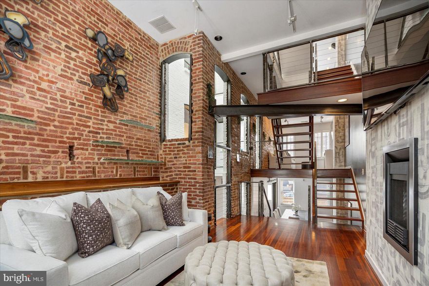 Fall in love with 2125 Cambridge Street!   This spectacular residence boasts nearly 3000 sq feet, 4 finished levels and unobstructed views of the Baltimore Harbor. This home is nestled between Canton and Fells Point, located within walking distance of World Class Restaurants and Retail Shopping. This custom renovation incorporates 2 homes and the joining sally that has a beautiful, modern architectural design that also extends a nod to its original historical charm.  Home characteristics include: Dedicated Office Space, Soaring 3 Story Atrium, Exposed Brick, Floating Staircases, Custom Iron Railings, Brazilian Cherry Hardwood Floors, Exposed Steel Beams, Professional Thermador Gas Stove, New Paint, New Carpet, New Skylights, Newer Sound Proof Windows, New High Efficiency Hot Water Heater, Trex Decking on the 1000 sq foot Roof Deck, Trex Deck off Kitchen for Grilling, Freshly Poured Concrete in Rear Yard, Laundry located on the Primary Floor, and Powder Room on the 3rd Floor for Roof Deck Entertaining. Your guests will love the 3 Story Atrium, Private Speak Easy Entrance, 3 Living Rooms and the spectacular Harbor Views.  This home also has a garage with an EV charging station.  Located just 2 miles from 95 and 1 mile from the train station (commute to DC).   

This is luxury Baltimore living at its finest — sophisticated, spacious, and impossible to duplicate.
Schedule your private showing today. This extraordinary property will not last long.