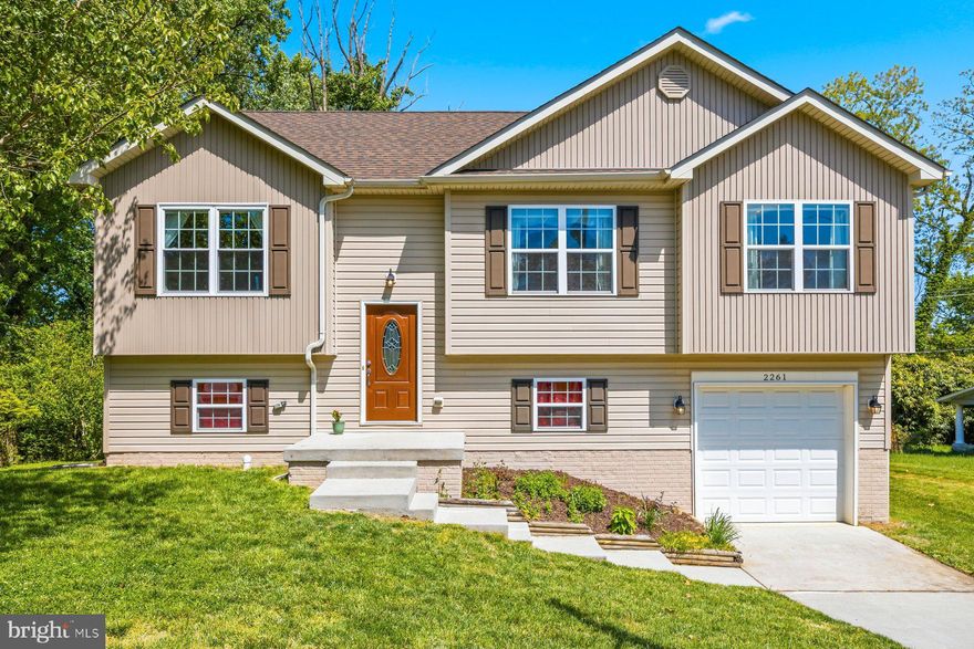 Check out this amazing, unique split foyer home, on a large lot, with many updates!  You'll walk into a nice sized entryway that opens up to a main level with cathedral ceilings, spacious open-level living, hardwood floors, and a vibe that you will love.  The main level consists of a separate living room and dining room area both offering plenty of space, plus a huge gourmet style kitchen with granite countertops, stainless steel appliances, tons of cabinetry and a large island space ready for entertaining, relaxing with family/friends or a solo night at home.  The whole house has an open feel, with recessed lights and tons of natural lighting too.  Down the hall, you will find three spacious  bedrooms.  A large primary suite with trayed ceilings, ceiling fan, a walk-in closet, and a modern en-suite full bathroom with shower and ceramic tile finishes.   Bedroom two and three are also good sizes and share the hall bathroom which has a tub/shower combination, and ceramic tile finishes.  Out back you will find a wood deck and a nice yard.  Heading downstairs, you will find spaces that don't feel like a basement, with raised ceilings, a large, open family room, a slider to the rear yard, lots of storage space and new carpeting, This basement is well lit and A+.  You will also find a separate laundry room with a double load washer, and builder included radon remediation system.  To the rear of the basement, a bedroom / full bath combination that is perfect for you or for guests.  The house also has an attached garage and driveway that walks into the basement and plenty of street parking out front - the second refrigerator in the garage will transfer.  This house is in the high demand area of Woodberry, near to Hampden, the Maryland Zoo, the Jones Falls Trail and the light rail.  Uniquely located on Park Hill Ave, which is a quiet tucked away neighborhood loop road that will have you feeling removed from the city crowds, yet still conveniently located with excellent accessibility to major highways/roadways (83, 40, 1, 695, Falls Rd), restaurants, shopping, entertainment and more.  Come fall in love and make this home yours.