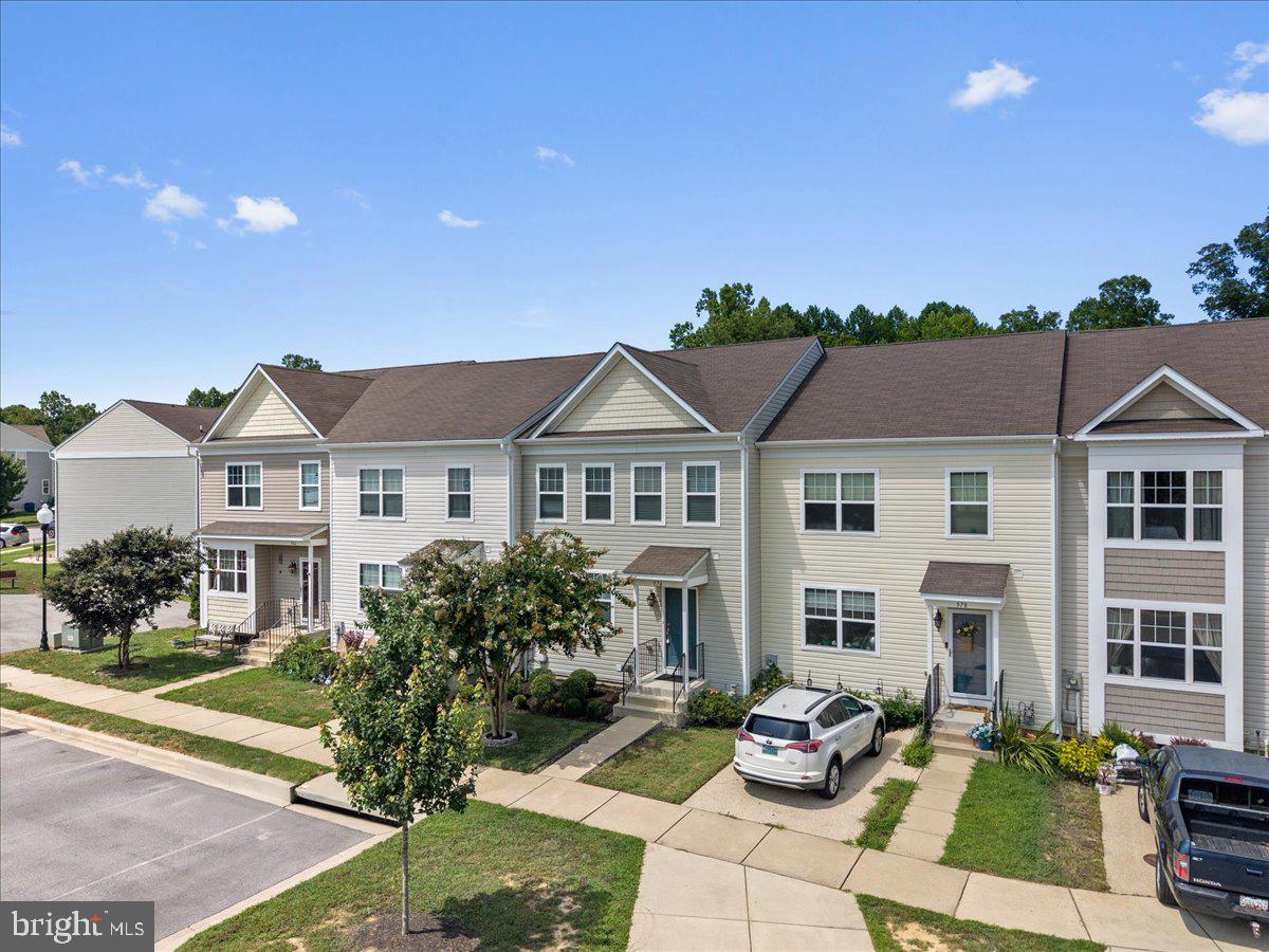 Only eight years old and ideally located in the heart of Prince Frederick, this home offers convenience to shopping, dining, and exciting new additions to the area including Aldi, Always Ice Cream, Fosters Grill, and First Watch. Inside, you’ll find a home that feels like a model, featuring new vinyl plank flooring throughout the main level, recessed lighting, updated fixtures, and blinds on every window. The open floor plan leads you into the kitchen that is designed with white painted cabinetry, granite countertops, and an open layout perfect for entertaining. The home backs to wooded views, offering privacy and a peaceful setting. Upstairs, the spacious owner’s suite includes vaulted ceilings, a walk-in closet, and a beautifully updated en suite bathroom with double sinks and a large tiled walk-in shower. Two additional bedrooms and a second full bath complete the upper level. The lower level features a mostly finished basement with a walkout to the backyard, gym flooring, and a combined storage and laundry room. Additional upgrades include a tankless hot water heater, an EV charger, and a filtered water system at the kitchen sink. Welcome to 574 English Oak Lane, and Oak Tree Landing, where thoughtful updates, a prime location, and pride of ownership come together.