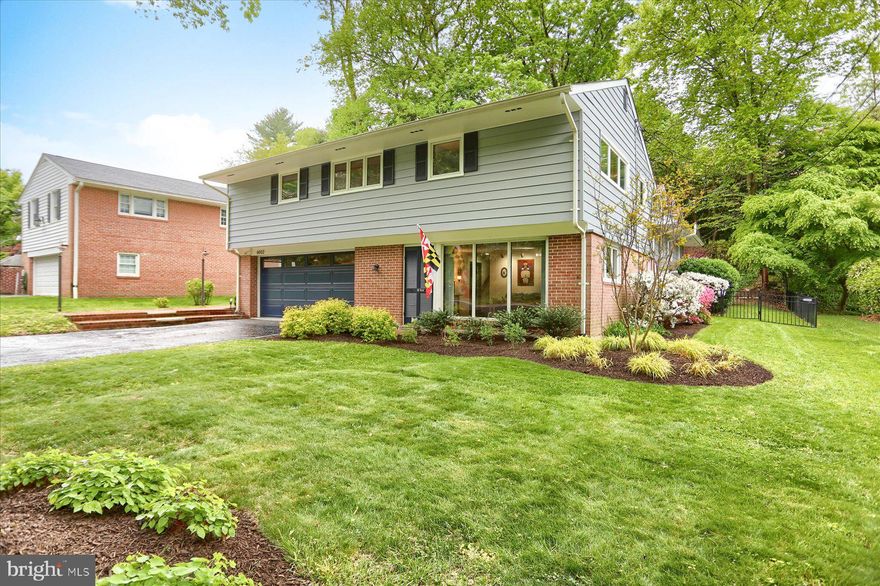 Welcome to 6002 Roland Avenue, a beautifully updated home tucked away in the heart of North Roland Park offering comfort, and thoughtful design! This lovely property boasts 4 levels, 4 bedrooms, 2 full bathrooms and 2 half baths. The first floor features vaulted wood ceilings with 3 dormers that flood the space with light, built ins and a gas fireplace  in the living room, and a powder room. The updated kitchen is a showstopper with a spalted maple island countertop, farmhouse sink, custom tile backsplash, quartz countertops, induction cooktop, and a spalted maple pantry door. Oversized glass doors, transoms, and windows brighten the kitchen, living room, and dining room. Upstairs is the serene primary suite with en suite bathroom, plus 3 additional roomy bedrooms and a hall bath. The lower level includes a comfortable family room, laundry room, and half bath. The lowest level offers plenty of storage in addition to the mechanicals. Outdoors, relax on the peaceful deck with a fenced in back yard. Other highlights include a 2-car garage, central vacuum, whole house generator with battery backup, and a beautifully landscaped setting. The roof was replaced in 2025 and the water heater in 2023.  Conveniently located near Lake Falls Village and Roland Park Eddies, and not far from the historic Roland Park Shopping center. Be sure to check out the 3D interactive virtual tour!