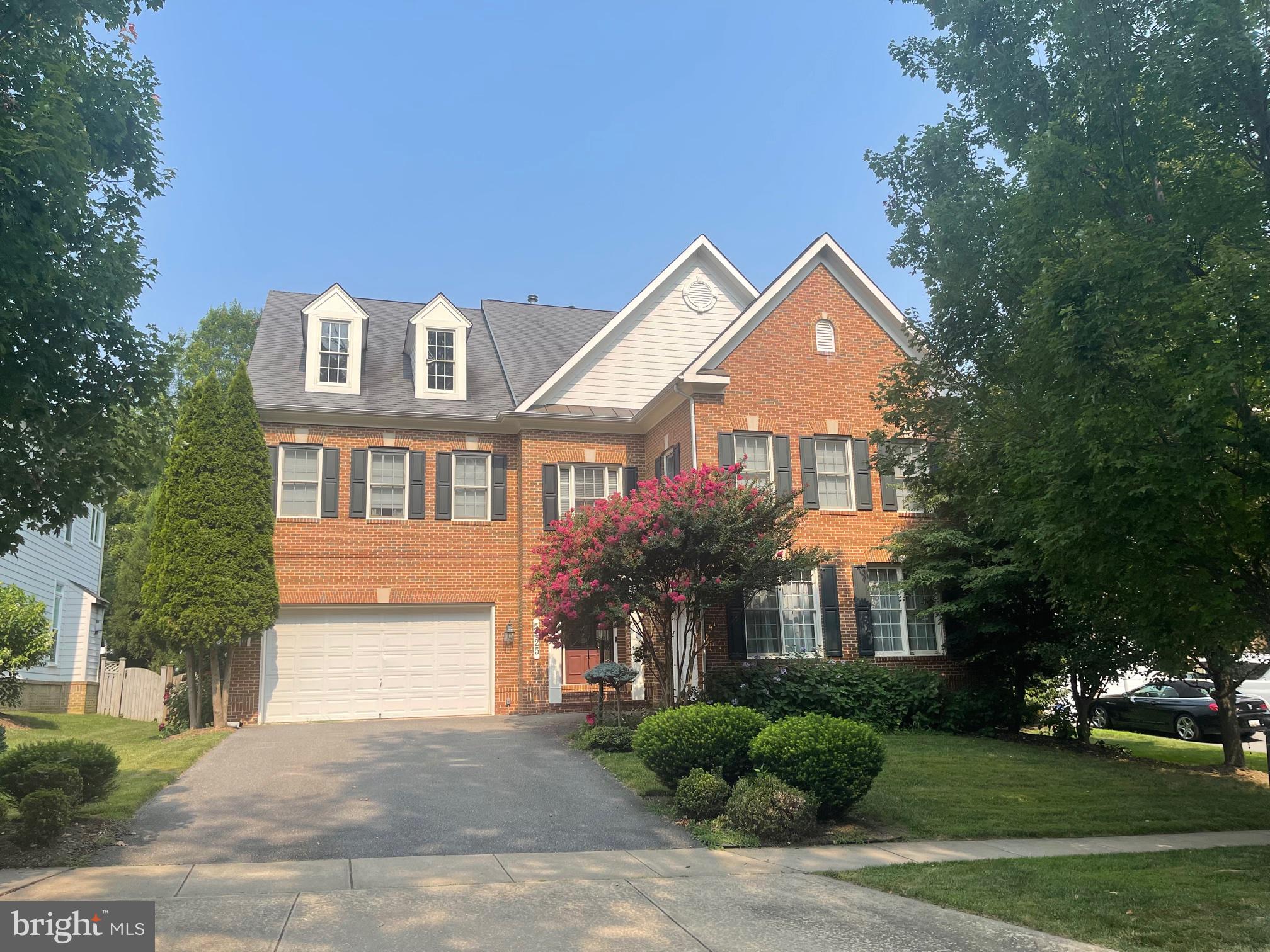 A rare find in a GREAT QUIET LOCATION! Just several blocks from NIH!!! This stately brick colonial offers exceptional space, comfort, and versatility with over 5,000 square feet of beautifully finished living area and 9-foot ceilings on all three levels. The open, light-filled floor plan features a spacious family room with soaring 10' ceiling, gas fireplace, custom built-ins, and hardwood floors throughout. The luxurious primary suite boasts a tray ceiling, elegant spa-like bath with double vanities, corner soaking tub, and oversized double shower. Enjoy the convenience of laundry on the bedroom level—plus a second laundry area in the fully finished lower level. Perfect for entertaining, the expansive basement includes a large rec room, second kitchen/bar, built-ins, full bath, and a pool table. The flat, fenced backyard with flagstone patio offers a private outdoor retreat. Situated on a peaceful street with both 2-car front-load and 1-car side-load garages—this home truly has it all!