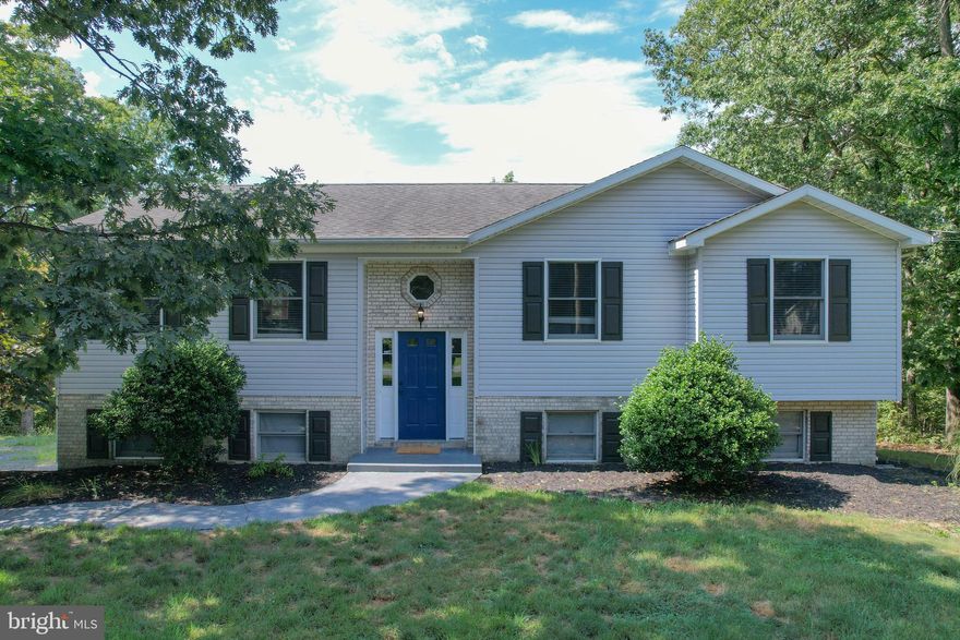 Come and see this spacious 4BR/ 3 BA split foyer is a private, lush setting amongst the trees in beautiful Foxcrest Manor.   Families rave about the school district and the open floor span and floor layout make way for your design and style mind to take flight.   The outdoor space is dreamy for afternoon reading on the back deck or games and fun on the patio below.  The garage is a work cave or she shed waiting to happen.  It is tucked away with plenty of room for your car and your hobbies.  
Inside the house, the main level features an open living/ dining room combo with in set kitchen.   The kitchen looks over the property from a perfectly placed sink window.   The sliding glass doors to outside make the dining room a great place to open the doors when hosting family and friends.   Gather around your giant sectional for a night of movies or an afternoon or sports in the huge living room.   The bedroom are down the hallway all featuring large closets and a shared hallway full bathroom.  The owner's suite is a large bedroom with walk in closet and full size bathtub and vanity.  The ground floor boast a great space  for an additional family room, bar, game room etc.   The downstairs bedroom is multi-purpose to fit your specific need. You will love the lifestyle conducive to living in the country- fresh air, trees to climb, trails to hike and rivers to ride.  Come to WV and see for yourself; book your private showing today!