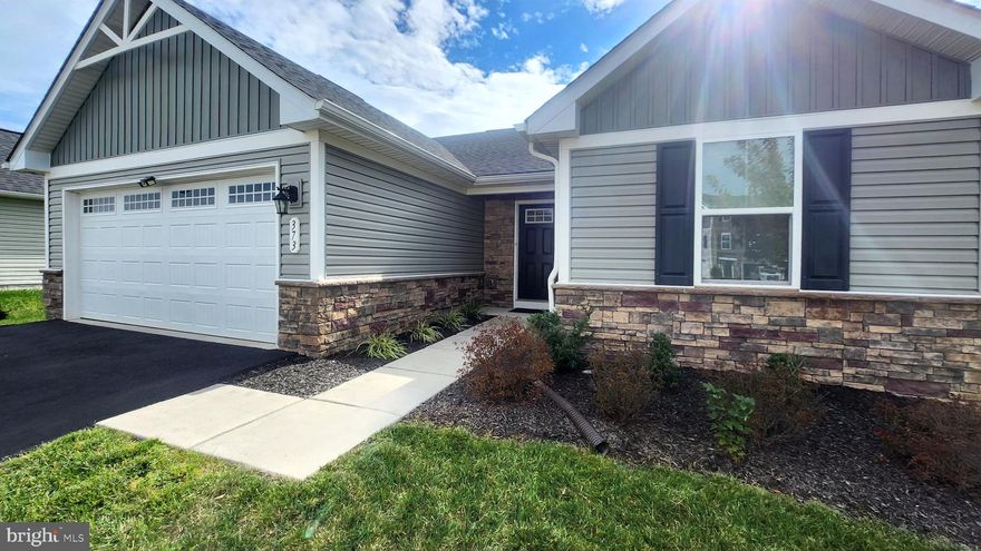 THIS PROPERTY IS PRICED TO MOVE FAST! Discover the perfect blend of comfort and modern living in this stunning ranch-style home located in the desirable community of The Lakes at Martinsburg. This property was previously used as a model home with many builder upgrades. Built in 2020, this meticulously maintained residence boasts 1,352 square feet of thoughtfully designed space ideal for both relaxation and entertaining. 
Step inside to find an inviting open floor plan that seamlessly connects the upgraded kitchen and family room. The kitchen is a chef's dream, equipped with stainless steel appliances, gas cooking, granite countertops, and a convenient island that encourages culinary creativity. The combination kitchen/dining area is perfect for hosting gatherings, while the family room off the kitchen provides a cozy space for everyday living. Enjoy the luxury of the entry-level bedrooms, perfect for family, guests, or as a private office space. The interior features include plush carpeting, ceramic tile, and durable luxury vinyl plank flooring, ensuring both style and functionality. The owner’s bathroom offers a large step in shower stall, a tankless water heater for instant hot water, and a 11’x5’ walk-in closet providing ample space for a large wardrobe. The attached front-entry garage provides convenience and additional storage, complemented by an asphalt driveway that accommodates multiple vehicles. A bonus feature is the level 2 EV charger. 
Outside, the property sits on a generous, well-manicured 0.23-acre lot, complete with a charming patio for outdoor relaxation and entertaining.
Living in The Lakes at Martinsburg means enjoying a vibrant community with an array of amenities. Take advantage of the common grounds, jog/walk paths, and a serene lake, perfect for leisurely strolls or picnics. The community also features tot lots, playgrounds, a pavilion, and a dog park, making it a wonderful place to enjoy the outdoors. Education is a priority in this neighborhood, with access to highly regarded schools that foster academic excellence. Nearby shopping and restaurants offer additional convenance, ensuring that residents can enjoy an active lifestyle. This exceptional property is not just a house; it's a place to create lasting memories. Experience the perfect combination of modern living and community charm in The Lakes at Martinsburg. Don't miss your chance to make this beautiful home your own!