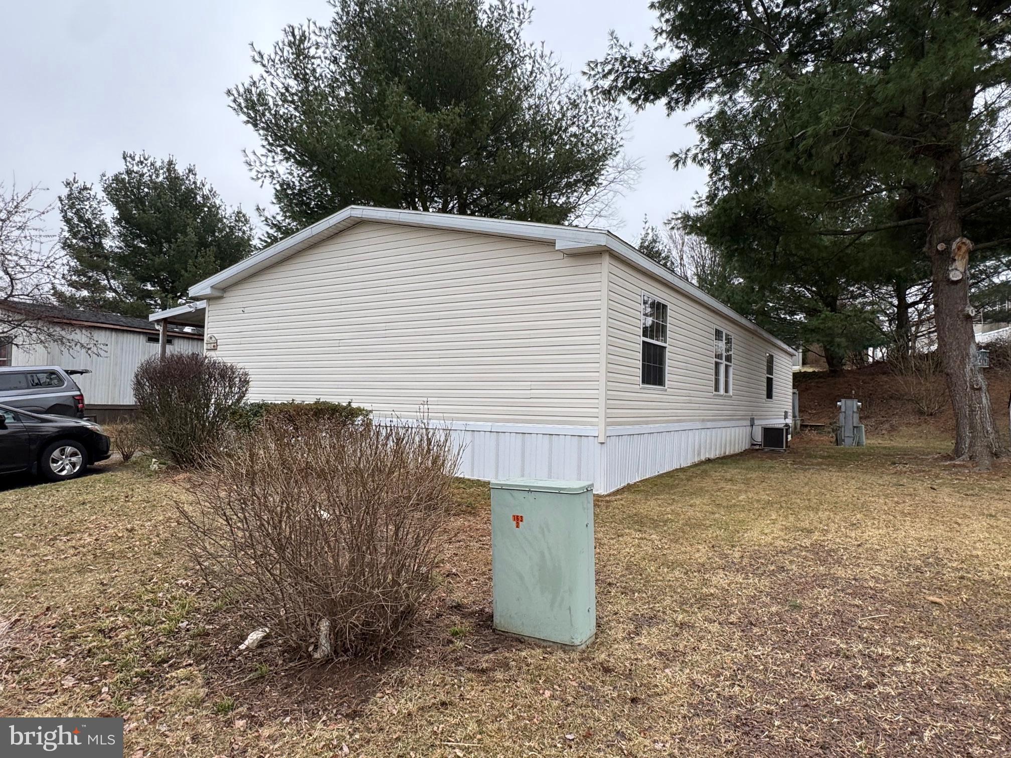 A well-maintained mobile home located in Mill Creek Estates, featuring three bedrooms and two full bathrooms. Built in 1998, this spacious residence offers 1,456 square feet of living space, highlighted by vaulted ceilings. Additional amenities include a sunroom, laundry room, storage shed, and rear and side patios, with a primary bedroom complete with an on-suite bathroom.