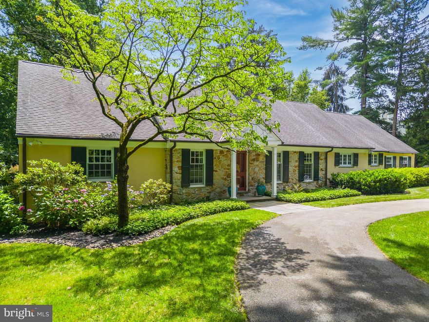 Welcome to 524 Telner St, a stunning two-story expanded cape home tucked away at the end of a long driveway on a quiet street in the heart of Chestnut Hill. This sunlit home offers lovely details such as hardwood floors, crown molding and wainscoting, as well as a beautifully landscaped outdoor space. The eat-in kitchen offers black granite countertops, Viking appliances, Sub-zero refrigerator, and a breakfast area overlooking the family room, creating a seamless flow for both everyday living and entertaining. The mudroom entrance features honed granite countertops, multiple storage cubbies, ample cabinetry for storage, and access to the 3-car garage, complete with small powder room. The family room is a cozy retreat with a gas fireplace and banquette window seat that offers a picturesque view of the exquisite backyard setting. Built-ins add functionality and style to the space.The formal living room is adorned with a gas fireplace featuring a reclaimed carved marble mantle and glass French doors that connect to a charming trellis covered slate patio. The formal dining room boasts an exquisit gas fireplace,  large windows that invite natural light, and original built-ins. Two large bedrooms, one ensuite and one with a bath that is also accessed from the hallway, complete the first floor. The second floor continues to impress with a guest bedroom featuring two closets, a sitting area, and a private ensuite bathroom. The primary bedroom offers a large sitting/entertainment area, built-ins, and a walk-in closet. This room provides access to a convenient second-floor laundry room. The basement offers ample storage space and the potential to add additional living space. The lush grounds of this charming home offer stunning perennial gardens, mature trees and a large rear yard. A charming slate patio with pergola, graced with wisteria, provides a tranquil area for entertaining or dinner under the trees. This charming gem is in a fantastic location, just steps from the Cresheim Trail of Fairmount Park, 2 blocks from 2 train stations, and just minutes from the shopping and dining along Germantown Ave.