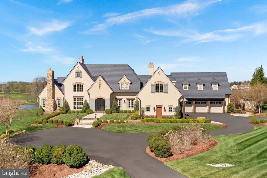 Imagine ending your day watching the most beautiful Loudoun County sunsets over the 7th hole of a Jack Nicklaus Signature Course—right from your private veranda! At Chateau Belvedere, a one-of-a-kind estate situated on 3 acres inside Leesburg’s exclusive Creighton Farms, that vision becomes your everyday reality. The home was designed and custom built by the renowned Galileo Signature, this tri-level residence is an architectural homage to English and French countryside manors, blending timeless elegance with modern craftsmanship over 14,000 sq ft of carefully curated interiors.

From the moment you approach the grand drive, every detail impresses. Meticulous landscaping leads you towards the grand entrance.  Inside, a floating curved staircase sweeps through the soaring foyer, illuminated by towering windows and anchored by curved walls that give the layout a fluid, gallery-like sophistication.

A refined formal living room with bespoke cabinetry hosts intimate conversations, while beamed ceilings crown the family alcove with its wet bar and French doors leading out to the heart of the home: The Belvedere—an open air veranda commanding the best panoramic golf course views in the neighborhood.

Culinary dreams come alive in a kitchen designed for both performance and beauty, complete with professional-grade appliances, a central prep island, and walk-in pantry. The adjacent breakfast nook feels like a European café, while the adjoining sunroom and heated patio each invite year-round entertaining. Your main-level primary wing offers a private luxury retreat complete with tray ceilings, fireplace, and a spa-inspired ensuite.

Upstairs, all four secondary suites have accompanying baths and ample storage.  Flexible living zones and a bonus kitchenette make this floor ideal for hosting or extended stays. 

A convenient elevator links all three levels, including a basement that rivals any resort: wine cellar with tasting room, exercise room, full size stage for concerts or recitals, cinema-style theater room, and the cozy fireside recreational area.

Step outside to enjoy the sweeping golf course views and the infinity edge pool with spa and fountain.   The outdoor spaces are thoroughly appointed, offering a full kitchen, exterior shower, and multiple conversation areas provide the perfect setting for all events large and small.  

Rounding out the home is a 3 car garage and an additional detached 2 car garage complete with 2 full size vehicle lifts.  Car enthusiasts can easily store  up to 7 vehicles indoors.  

The home also has a 1 year old Synthetic Slate Roof, Newer Geothermal Units and Commercial Whole House Generator.  

All of this and conveniently located near James Monroe Highway 15, Leesburg Airport, Washington Dulles Airport, and the Dulles Toll Road.   Chateau Belvedere isn’t just a home—it’s a world unto itself. 

Come experience the intersection of luxury, leisure, and legacy!