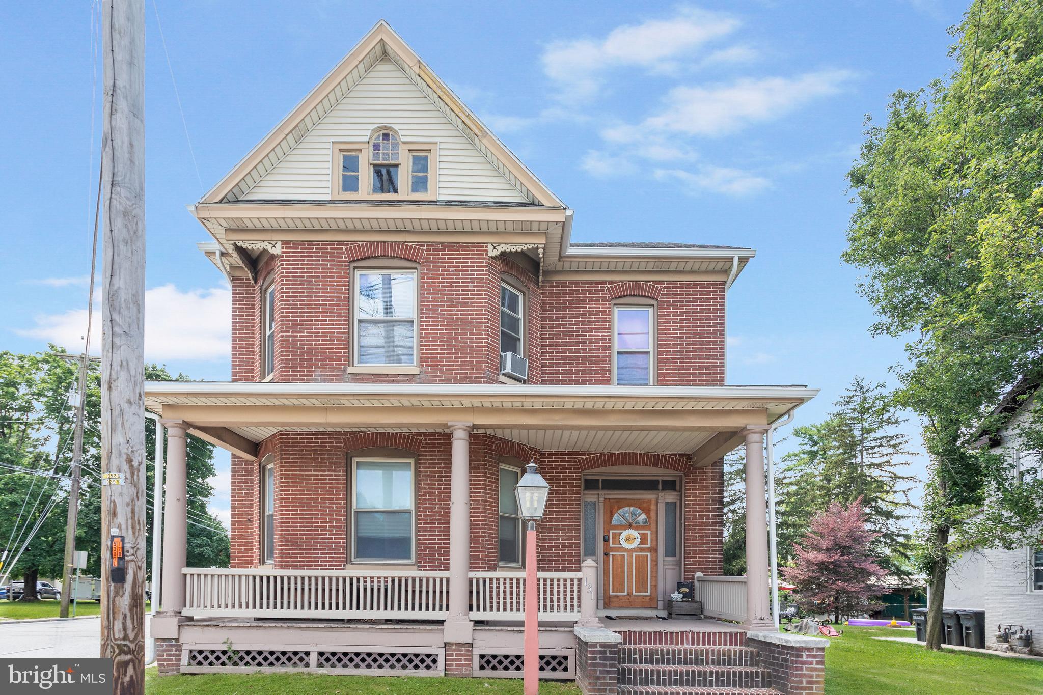 This classic 2-story home has a warm and welcoming vibe with its red brick exterior, covered porches, and large windows. Inside you will find wood floors, original trim, pocket doors, and modern conveniences like an updated Kitchen with a dishwasher, stove, microwave and refrigerator. Both the Living Room and Dining Room have bump outs adding extra space to the rooms. Laundry and a Half bath complete the 1st floor. Upstairs you will find 3 comfortable size bedrooms with plenty of space to spread out and a bonus room that could be used as an office, computer room, walk-in closet, etc. The Full bath has a shower stall and separate tub. Walk-up attic for extra storage. Enjoy evenings and weekends outside on the 15x20 stamped concrete patio. Level backyard could be fenced. Conewago Valley school district, close to New Oxford square and major driving routes (US30/PA94).