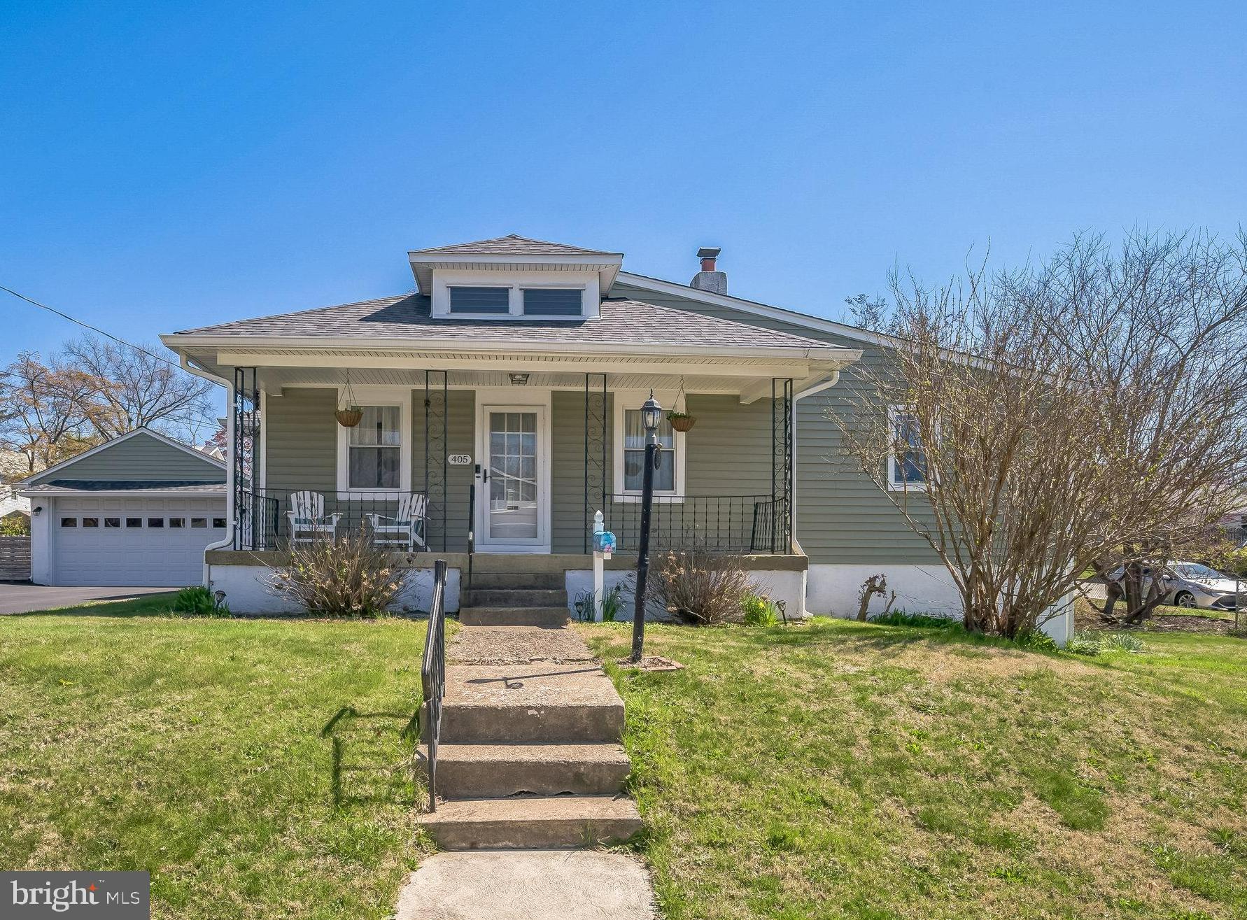 Welcome to this beautifully renovated 3-bedroom, 2-bathroom bungalow that seamlessly blends timeless charm with modern comforts. Nestled on a generous, level corner lot, this move-in-ready gem not only delivers everyday comfort, but also offers exciting potential for future expansion. Whether you're looking for a stylish home today or envisioning growth down the line, this one has it all. A covered front porch sets the tone—inviting you to sit back, relax, and enjoy the neighborhood. Inside, you’ll find a spacious living room featuring gleaming hardwood floors, a classic stone fireplace, and custom built-ins that create a perfect focal point for cozy evenings. The formal dining room adds even more character, complete with charming built-ins—ideal for hosting holiday dinners, family meals, or intimate gatherings. The kitchen is a true showstopper—a dream for any home chef! Boasting abundant cabinetry, sleek granite countertops, double oven, a built-in bar fridge, and a breakfast counter with seating for two, it's designed for both functionality and style. Thoughtful touches like well-placed outlets make it easy to accommodate all your favorite kitchen gadgets. Just off the kitchen, a covered patio provides the perfect setting for morning coffee or outdoor entertaining. The home offers three spacious bedrooms and two beautifully updated full baths. The primary suite is generously sized and features ample closet space and a stunning en-suite with a double sink vanity and large stall shower. The second bedroom sits conveniently near the hall bath, which includes a full tub and houses the laundry—no more trips to the basement! The third bedroom, currently used as a home office, includes a full staircase to the attic—great for storage or a fantastic opportunity to expand upward. A full basement that was just professionally waterproofed (this month) provides additional storage and houses the home’s updated mechanical systems, including a gas heater and gas hot water heater. Nearly every major system has been updated in the past decade, ensuring peace of mind for years to come. Out back, the covered patio overlooks a lovely yard—ideal for BBQs, playtime, or quiet relaxation. The oversized two-car garage is a rare find—perfect for hobbyists, car lovers, or anyone in need of extra space and has an EV charger! An extended driveway provides off-street parking for up to five cars, making entertaining and daily life extra convenient. Location? You couldn’t ask for better. Just a short stroll to the train station, shops, 3 township parks/ball fields, and the community pool. Plus, you’re in the highly regarded Copper Beech Elementary School—a true neighborhood highlight. Lovingly updated and meticulously maintained over the past 10 years, this home is completely turnkey. All the work has been done—just move in and enjoy. Don’t miss this rare opportunity to own a fully renovated, character-filled bungalow with room to grow in a fantastic, walkable location. Hurry—this one won’t last!