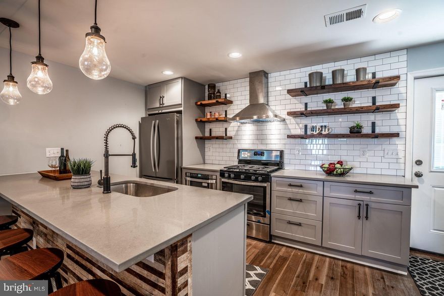 PERCHED AWAY FROM THE STREET THIS URBAN RUSTIC RENO BOASTS OPEN FLOOR PLAN, 3 BRs (ALL ABOVE GRADE!) 2.5 BAs & CHEF S KIT BOASTING LRG ISLAND, SS, GRANITE, SUBWAY TILE & RECLAIMED WOOD! TRULY PRIVATE OWNERS SUITE W/ SKYLIGHTS, VAULTED CEILINGS, WIC & VINTAGE CHIC EN SUITE. REAR DECK & FRONT PORCH PERFECT FOR ENJOYING A COCKTAIL W/ FRIENDS. 3-CAR PARKING + A YARD FOR YOUR PUP! 2 BLOCKS TO THE AVE!