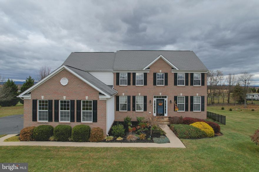 EVERYTHING YOU WANT!  Spacious 4BR/ 4BA brick faced colonial in prestigious Quarter Farm is Coming Soon boasting 3 acres of opportunity to bring your horse(s) and add a barn.   With over 4,500 SF of country living space, this open floor plan includes an updated gourmet kitchen with new energy efficient stainless appliances including a double wall oven and center island cooktop!  You will love sitting in the sunlit morning room with views of pastureland while enjoying your favorite meal.   The earth-toned ceramic tile floor and hardwood create a warmth in the freshly painted kitchen.   The kitchen island is a gathering place with the morning room combination lending to entertaining, conversations and making lifetime memories. Next to the kitchen is the spectacular two-story living room with floor to ceiling stone gas fireplace.  Get ready to spend cozy winter nights nestled by the fire to watch WV's freshly fallen snow through large feature windows.   Retreat to the separate main floor office or have a main floor bedroom, dining or sitting room for more privacy and quiet.  For convenience,  a half bath and separate laundry room are maintained on the primary level.   The grand front foyer features hardwood floors and a wooden staircase with classy wrought iron balusters. On either side of the main foyer entrance, in classic colonial style,  are two large rooms traditionally a formal sitting room and dining room.  Upstairs, you may overlook the main living area while retreating for the day.   Three bedrooms are ample sized with large closets and a shared full shower/ tub combo bathroom.    The primary ensuite includes a double suite bedroom with walk in closets, sitting area, an in-room exercise or office space.   The primary bath includes a garden corner soaking tub with separate stand up shower, double sink vanity and cabinetry.  Bring your decorating prowess as endless beauty awaits for you to make these spaces your own! 
The walk out basement is an added bonus with another nearly 1,000 SF finished space and more unfinished space for storage and treasures.   Brand new high efficiency hot water heater, water treatment and utilities are housed in the basement with easy maintenance access. A three car, remote entry garage provides warmth from car to home.   
The outside landscapes and hardscapes of this home match the inside beauty.   Large, easily maintained composite deck with stairs to a yard full of lush grass, seasonal flowers and boundless entertainment space.   Enjoy the cottage potting  house for your landscaping implements and outdoor storage. Whether you want the privacy of country living or the space to host the grandest parties, 121 Paso Corto will meet all your expectations; plan your tour today!