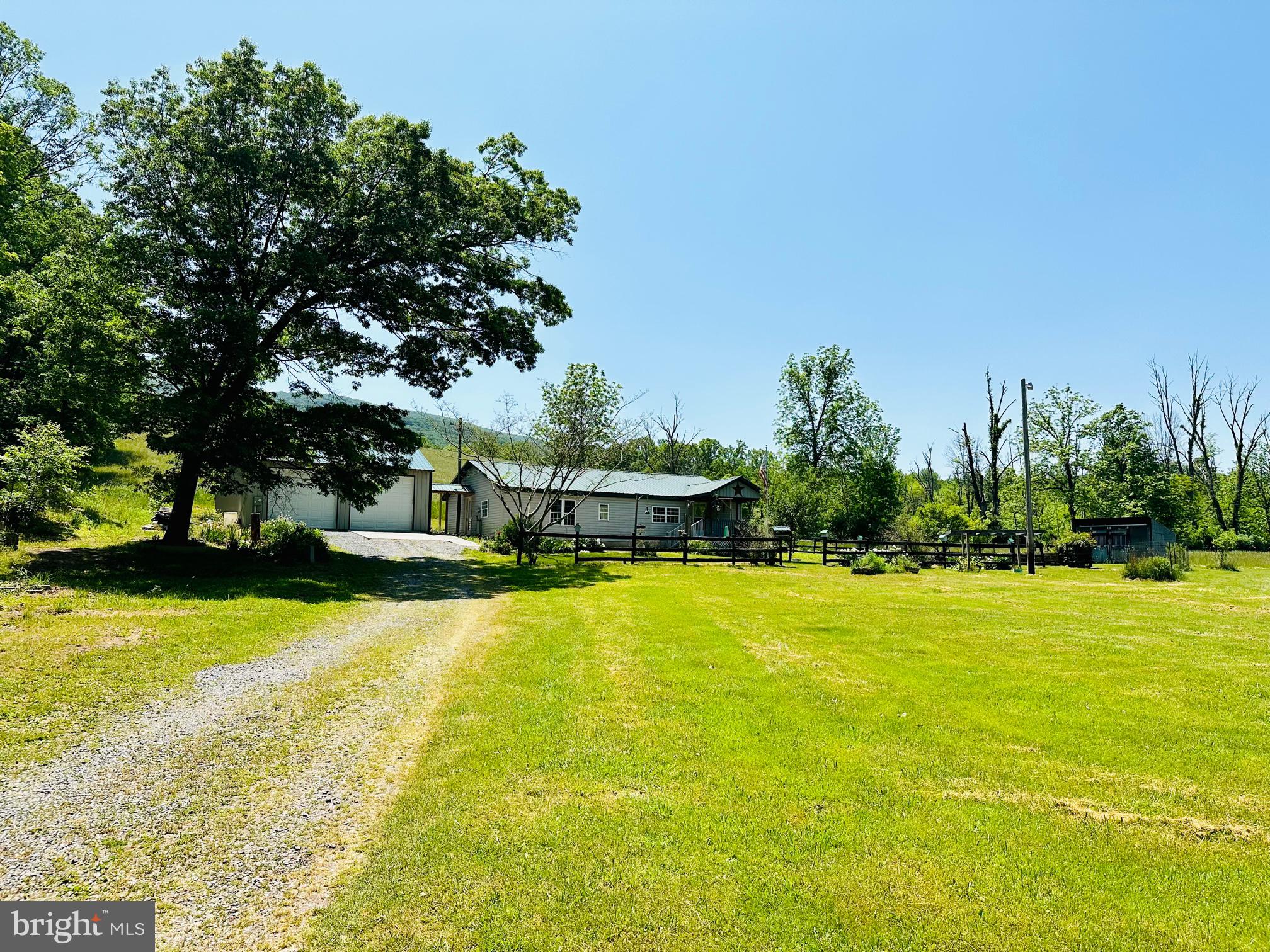 *** SELLER IS WILLING TO CONSIDER BACK-UP OFFERS AT THIS TIME***
COME AND SEE THIS 3+ ACRE WV MOUNTAIN FARM-ETTE THAT HAS NEARLY 2 ACRES OF PASTURE AND AN IMPRESSIVE OVERSIZED DETACHED GARAGE (28' X 47') WITH AN ATTACHED WORKSHOP (16' X 28')! THE OVERSIZED GARAGE HAS ITS OWN POWER SOURCE WITH CONCRETE FLOORS, A HALF BATH AND A MOP SINK. THE PRIVATE UNRESTRICTED ACREAGE BOASTS A STREAM THAT RUNS ALONG THE EDGE OF THE PROPERTY. THERE ARE PLENTY OF MATURE FRUIT TREES THAT INCLUDES APPLE, PEAR, CHERRY AND PEACH TREES. THE FLOWER BEDS HAVE ESTABLISHED PLANTS TO INCLUDE LOVELY ROSE BUSHES. THERE IS A WATER FEATURE IN THE BACKYARD THAT IS A FOUNTAIN WITH A FISH POND. THERE IS A PORCH ON THE BACK OF THE HOUSE FOR BONUS OUTDOOR LIVING SPACE. FOR THE LIVESTOCK ENTHUSIASTS THERE IS A TWO STALL BARN WITH A RUN IN FOR LIVESTOCK. THE INTERIOR OF THE HOME HAS A LARGE LIVING ROOM AND COMBINATION KITCHEN AND DINING ROOM. A PORTION OF THE HOME HAS BEEN RECENTLY REMODELED.