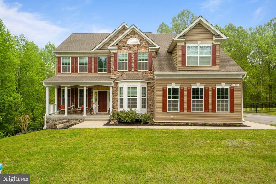 WELCOME HOME to 12135 Edonton Place!!! This stunning over 4,000 sq ft Colonial sitting on 3.5 acres has been meticulously maintained by the current owners and it shows!!! Make your way up the driveway soaking in the desirable curb appeal with extensive hardscaping, 2-car garage, flat, level & usable fenced in yard backing to woods, and front porch... perfect for enjoying peaceful mornings! Enter the front door to  open concept layout with gleaming hardwood floors, 2-story foyer, and formal living room with tray ceilings, wainscoting, & recessed lighting. Formal dining room also off foyer with bump-out window.  Gourmet kitchen features granite countertops, double wall ovens, built-in microwave, gas stove top, side-by-side fridge with ice maker, backsplash, spacious breakfast area with sliding glass door leading to backyard custom patio, and overlooks bright & airy family room with gas fireplace! Off kitchen is MAIN LEVEL BEDROOM and FULL bathroom! Upstairs boasts primary bedroom with tray ceilings, not one but TWO walk-in closets with custom organizers, primary bath attached with double sinks, soaking tub, and oversized shower with double shower heads. Upstairs also includes 3 additional nicely sized bedrooms all equipped with ceilings fans and a hallway bath with double sinks! Bring the party downstairs to unbelievable fully finished basement with theater area including a movie projector system & screen, custom bar with wine fridge, full bathroom, unfinished storage room, and walkout level to backyard! But wait... there's more!!! The fenced-in level yard (lot extends far past fenced-in area on the right hand side... approx. 8 ft from neighboring driveway) features a 20x12 shed and HUGE custom paved patio with built-in firepit... who's ready for summertime BBQ's?! Run don't walk... This stunning home will sell itself as soon as you pull into the driveway!!