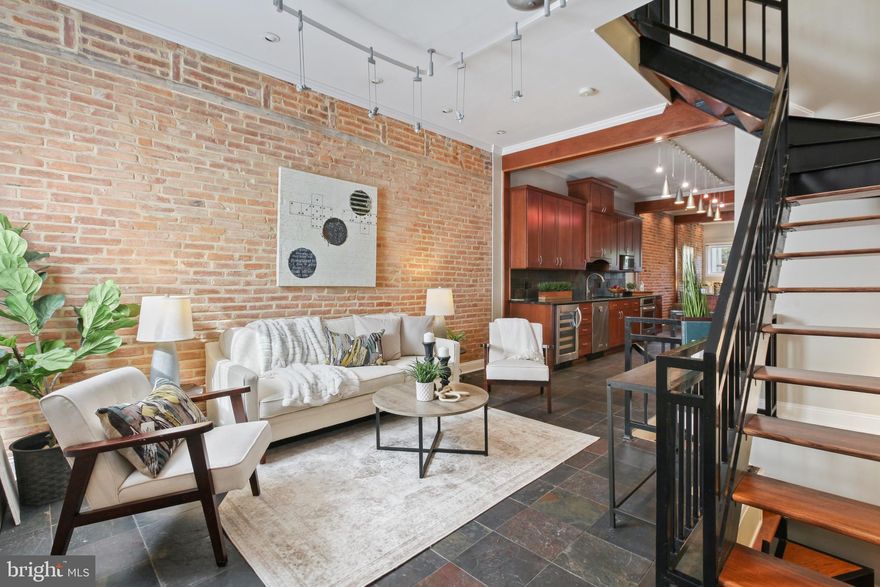 Welcome to 106 East Montgomery Street, where urban living meets modern luxury in the heart of Federal Hill. This renovated 3-bedroom, 4.5-bath townhouse spans an impressive 2,700 square feet, and it's a must-see gem in one of Baltimore's most coveted locations, Historic Federal Hill. Upon entering, you'll be greeted by a spacious, open living area that seamlessly connects to a custom kitchen featuring cherry cabinets, a stand alone 5-burner gas range, stainless steel range hood, granite countertops, and a breakfast bar. The main level also offers a separate dining space and an additional living room with a cozy gas fireplace that opens to a private patio, perfect for outdoor entertaining. Moving to the second floor, you'll find two large bedrooms adorned with gleaming hardwood flooring and two more full bathrooms. Ascend to the third floor, and you'll discover the luxurious primary bedroom suite, complete with a sitting room that leads to a grand rooftop deck with breathtaking panoramic city views. The master bedroom features another gas fireplace, a walk-in custom closet, a balcony, and a stylish master bathroom with dual sinks and large frameless glass shower. The lower level offers a spacious bonus living area and full bath, which can also serve as a fitness room or extra bedroom. Enjoy all that Federal Hill has to offer including the newly renovated Cross Street Market, Federal Hill Park, sporting events at Camden Yards & M&T Bank Stadium, and summer outdoor concerts at Pier Six.