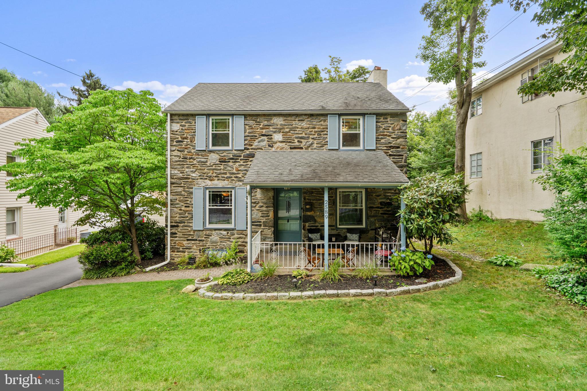 Welcome to this beautiful stone-front colonial, situated on a quiet tree-lined street. You'll immediately fall in love with the charming curb appeal, as you are welcomed by the covered front porch. Step inside to find the perfect colonial layout, with plenty of space for comfortable living. Some attractive features include hardwood flooring, brick fireplace, and a kitchen with recent updates. The kitchen has lovely countertops, 42" cabinets for all your storage needs, and stainless steel appliances with gas cooking! Head upstairs to find a nicely sized main bedroom, plus two more bedrooms, and an updated full bathroom. There is access to a 2nd story deck which is a perfect retreat for early morning coffee or night time stargazing. Still need more space? Check out the partially finished basement, ideal for a media room, exercise space, playroom etc., and it also features another full bathroom! Plenty of parking with the driveway and attached 1-car garage. But the feature you may love the most about this home is the park-like setting of the backyard. Beautiful mature landscaping surrounds a fully-fenced backyard, giving privacy and a sense of calm. Imagine spending your down time relaxing out back in your own oasis...grilling, gardening, or just enjoying the company of family & friends. There is a stone patio and storage shed too! All of this is located in Marple Newtown School District, with ultra low taxes! Close, easy access to the fantastic neighborhoods of Media, Ardmore, Newtown Square, and all of the incredible cultural, dining, and shopping destinations of the Main Line!