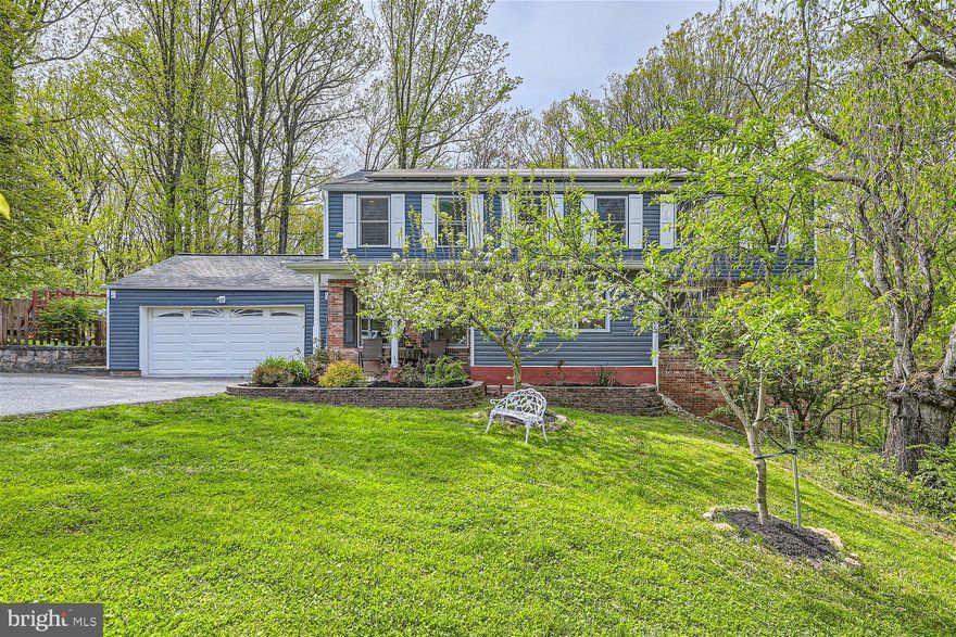 Pristinely maintained 7BR/3.5BA expansive Colonial located on just under two acres a quiet neighborhood. Pull into the extra wide/long driveway, park in front of a two car garage, past by the beautiful landscaping surrounded by stone hardscaping on the way to the covered front porch of your forever home. Step inside to a home filled with tons of natural light, hardwood flooring, and an abundance of living space.  The main floor offers an open concept floor plan featuring an oversized family room with a wood burning stove insert surrounded by a brick hearth and wood mantel. The kitchen is abundant with cabinets finished to the ceiling with crown moldings, a built-in pantry closet, stainless steel appliances, beautiful granite countertops with a complementing tiled backsplash, a deep double sink under a window, and a large peninsula with breakfast seating for three or more. A formal dining room is located within steps of the kitchen making for the ideal entertainment space. In addition, a half bath and access to the two car garage completes the main floor.  On the second floor are four spacious secondary bedrooms, a full bath with a double sink vanity, and an oversized primary bedroom offering a walk-in closet, and private bath with a double vessel sink vanity and a walk-in shower.  The lower level is finished featuring the sixth and seventh bedrooms with above grade windows, a full bath with walk-in shower, a colorfully painted family room with a wet bar and mini fridge, a laundry room with an additional half bath, storage, and sliding doors to a covered paved patio in an amazing yard.  The large deck off the kitchen is beautifully designed to ensure no matter where you stand you have views of the stunning surrounding scenery, including the built-in two-tiered Gazebo. An exclusive bonus to this already awesome property is a custom outdoor Sauna, just imagine how relaxing your new home will be.  Throughout the yard you will find a child's play area, a garden for vegetables, a fire pit area with seating, and an abundance of land to explore and enjoy.  This home is move-in ready with so much to offer new homeowners.  Imagine all this and in close proximity to shopping, restaurants, and commuter routes.