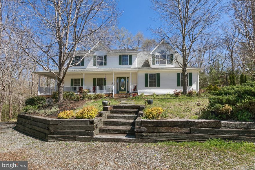 Welcome Home!  This home is perfect for a family  who wants a little slice of Heaven here in Southern Maryland.  This house is situated on 3.08 acres that are surrounded by woods and it boasts 5 full bedrooms and 3.5 baths.  The gourmet kitchen is luxuriously equipped with granite counters and island and a    large farm style sink.  The kitchen range is a              6-burner professional gas range along with two dishwashers in the kitchen.  The microwave is installed below the counter top and it is also a convection     oven.  There are several doors and windows off of the kitchen to a very large/spacious deck that runs the length of the house with a gazebo for style and shade; this space is perfect for entertaining and enjoying the outdoors.  There is a finished basement with a walkout sliding door.  The back yard has two large storage areas under the deck perfect for lawn or outdoor equipment.  There is a detached carriage house style garage with an connected workshop and lots of storage in an upstairs attic space.  The lot has an additional terraced pad that would be perfect for a pool or other gathering / recreation space.          Enjoy the sunset at the end of the day on the wrap around front porch with your favorite beverage.       Make your appointment to come see this property   today.
