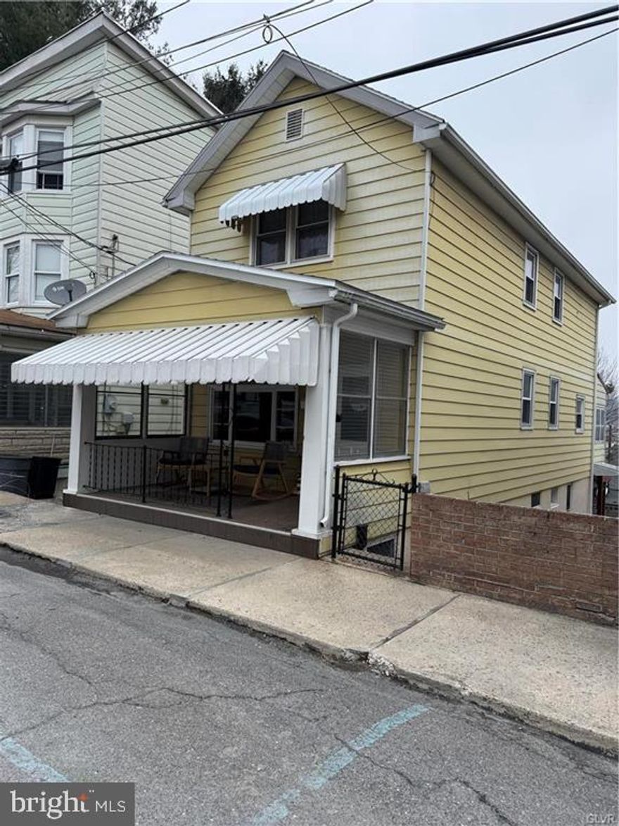 What a charming 3 bedroom 2 bath home in the borough of Tamaqua.  The newly updated full bathroom has a stunning sliding shower glass door, new flooring, and floating shelves.  Enjoy the second-floor laundry room, or convert it back to the third bedroom.  The newly exposed hardwood flooring downstairs is absolutely stunning.  The open floor plan is perfect for entertaining family and friends during any holiday.  Feel comfortable while your furry friends and little ones have room to run and play in the fenced-in yard.
Sit and sip your morning coffee on the enclosed sun porch every morning.  The lower-level family room is an additional perk for sure. Not to mention the outside entrance to the backyard.  All you need to do is move in.