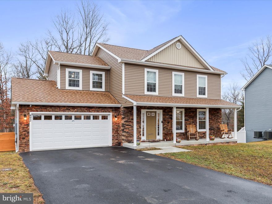 Welcome to this stunning Colonial-style residence, built in 2024, offering a perfect blend of modern elegance and functional design. Nestled on a generous 0.31-acre lot that backs to Middle Creek, this property provides a tranquil retreat while being conveniently located for commuters. Step inside to discover an inviting open floor plan that seamlessly connects the living room, dining room and gourmet kitchen, ideal for both entertaining and everyday living. The kitchen boasts upgraded countertops, an island for additional prep space, and high-quality appliances, including a built-in microwave, dishwasher, electric oven/range, and refrigerator. The island seating area is perfect for casual dining, while the living room features a cozy gas fireplace, creating a warm ambiance for gatherings. This home offers FIVE spacious bedrooms, each with a ceiling fan and light. The luxurious primary suite includes a walk-in closet and an en-suite bathroom featuring double sinks and modern fixtures.  The fully finished daylight basement with walkout access provides additional living space, perfect for a home office, gym, or entertainment area. The basement was finished professionally by the original builder. Enjoy outdoor living on the expansive deck, surrounded by nature's beauty.  The rear yard is partially fenced for your fur babies. The property includes an insulated, attached two-car garage and a paved driveway with additional parking for guests. Experience the perfect balance of comfort and style in this exceptional home, where every detail has been thoughtfully designed for modern living. Don’t miss the opportunity to make this property your own!  No need to wait months for new-construction or pay the WV transfer taxes that comes along with buying a new home. This is just about brand new and move-in ready!