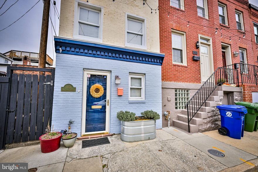 Welcome to this sun-filled two bedroom, two full bathroom end-unit rowhome offering the perfect blend of privacy and city living in the heart of Baltimore. As you enter the house, step inside to a bright, modern kitchen featuring open shelving, updated countertops, and a classic subway tile backsplash. The back door leads to a fully fenced backyard, providing an ideal space to relax, for outdoor entertaining, or gardening. With a secluded courtyard-style rear patio and thoughtful updates throughout, this home truly feels like a private urban retreat. The second level offers a spacious bedroom, a full bath, and the convenience of in-unit laundry. The third floor is dedicated to a private primary suite with its own full bath, creating a comfortable and functional layout. Enjoy being just steps from Federal Hill’s popular restaurants, bars, stadiums, parks, and museums—everything the city has to offer is right outside your door. Recent upgrades include a new roof, new HVAC system, and newer water heater for added piece of mind. An exceptional rowhome in one of Baltimore’s most sought-after neighborhoods.