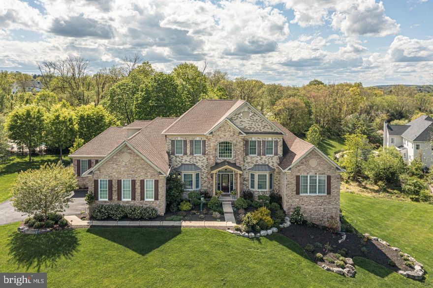 Located on a premium lot in Dutchess Farm Estates, proudly sits this Covington Heritage model with amazing views and incredible upgrades throughout. A gorgeous elevation of brick, stone and Hardie Plank siding, this beautiful home welcomes you at every turn. Beginning with its covered portico and stunning 2 story foyer that fans to the rest of the home. This home features a main floor Primary Suite, Cherry paneled elevator servicing all 3 levels, impressive 10' first floor ceilings, detailed moldings, architectural columns and beautiful dark hued 5" walnut hardwood flooring. With a perfect blend of formal and informal spaces, the open layout concept has the living room and dining room open to each other creating a wonderful flow for entertaining. Truly the heart of this home is its spectacular gourmet kitchen featuring 42"custom made walnut cabinets, heated tile floors, granite countertops, wine storage, and stylish pendant lighting. Meal prep is a breeze with a Wolf 6 burner cooktop, paneled Sub Zero refrigerator, pot filler, and large center island with prep sink and seating. Adjacent is the oversized breakfast area with access to the covered terrace. Ideal for daily living and entertaining, and heated for use all year round, the terrace features a beadboard ceiling, multiple dining and lounging areas along with an outdoor kitchen outfitted with a grill, burners, and refrigerator for all of your hosting needs. Back inside, is the light-filled gathering room featuring a wall of windows, floor to ceiling stone fireplace, and access to the Spa Room. This custom retreat houses an 8-person swim spa, sauna and full bath that completes the vacation-at-home feel. Offering wonderful versality, the study is a cozy place to take care of business, play a board game, or read. Conveniently located on this level is the primary suite with its vaulted ceiling, sitting area highlighting Jericho Mountain views, spa-like bath consisting of a sumptuous free-standing tub, oversized walk-in shower with multiple heads, separate vanities, heated tile floors and 2 large walk-in closets outfitted with professional organizers. The upper level features a spacious loft area currently utilized as an entertainment/game room, a Princess Suite, and two additional bedrooms sharing a Jack n’ Jill bath. Continuing to impress, the walk out lower level has extra ceiling height and has been thoughtfully designed for all your entertaining needs including a custom bar, game area, media room, billiards area, exercise room and full bath. An abundance of light fills this level with a wall of windows and French doors that lead out to the paver patio. Additional features of this amazing home include remote controlled shades, 3 car garage, security system, whole house generator and more. Located in the Council Rock School District, close to New Hope and Newtown for shopping and dining, and close to I-295 for commuting. This is home is a must see to appreciate all of the beauty it has to offer!