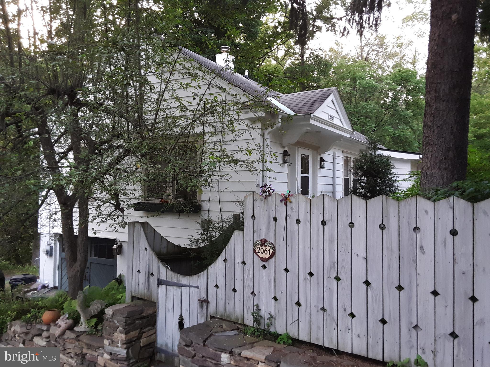 This single family home in a wooded setting feels like you're in the country, while being only minutes from dining, shopping, and the train station. Minutes from the Schuylkill River Trail and the Wissahickon, and the property backs up to a private forest. This home has 3 bedrooms, one of which is well-appointed for use as an office, and 2 full bathrooms. The kitchen features a sunny breakfast nook and appliances that are less than five years old. The finished basement is a walk-out and includes a laundry room, full bathroom and large storage area. A one car garage and outdoor spots offer parking for 3+ cars. A full attic is accessible by stairs from the second bedroom and can be used for storage, or could be converted into a third floor living space. The water heater is new. The lowmaintenance garden blooms from February through November.