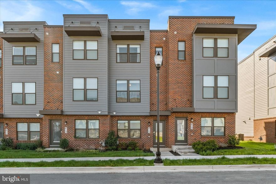 Welcome to this beautifully appointed 3-year-young townhome, walkable to vibrant Downtown Frederick! Offering 4 bedrooms and 4 full bathrooms, this thoughtfully designed home stands out with a rare and highly desirable layout - EACH BEDROOM FEATURES ITS OWN FULL BATHROOM, EVERY LEVEL OF THE HOME INCLUDES A BEDROOM, providing exceptional flexibility and privacy for guests, family, or a home office. Upon entering the foyer you have a generous amount of space for a drop zone and greeting guests.  You'll also find a bedroom with a walk-in closet and en suite bath.  Upstairs the main living space invites you in with an open-concept layout, 9 ft ceilings, LVP flooring throughout, a bright living/dining area and a modern kitchen equipped with stainless steel appliances and quartz countertops. Then step outside to the deck for easy indoor-outdoor living. This level also includes a bedroom and full bathroom. The upper level includes a convenient laundry area and two more bedrooms, including the spacious primary suite featuring a large walk-in closet and full bath with dual vanities, while the secondary bedroom also offers its own en suite bath.  Additional highlights include a garage for parking and storage, along with a community full of amenities—clubhouse with fitness room, pool, playgrounds and a dog park!