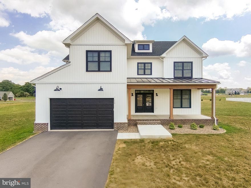 Welcome Home.  You will fall in love with this modern farmhouse which is situated on over an acre of level land.  The front porch welcomes you to come sit awhile.  As you walk through the double front door, you are greeted by an open and airy foyer, with a home office or 5th bedroom on your right. Down the hall is your open concept living space with a large living room, dining area and a kitchen that any cook would love.  Off the dining area is access to the large covered rear porch where you'll enjoy your morning coffee or unwind at the end of the day with a glass of wine.  The upper level has a large primary suite with a luxurious bath and huge walk-in closet, 3 additional large bedrooms, a full bath, laundry room, and open loft area.  The lower level is a blank slate that will allow you to design the man/lady cave of your dreams.