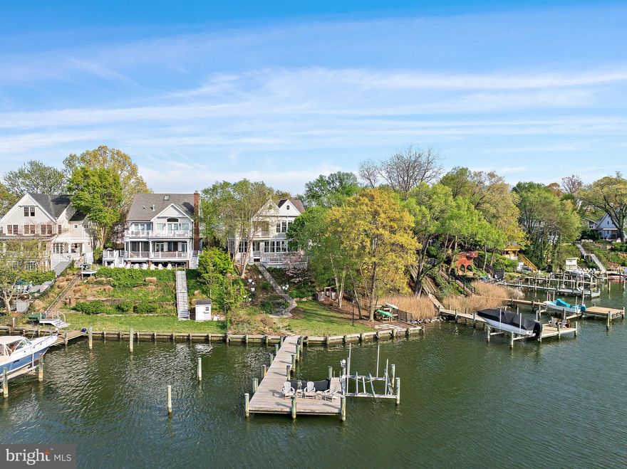 A stunning waterfront residence on Spa Creek, The Spa Creek House is a custom home designed by Alt Breeding Schwarz Architects with a landscape plan by Forested Creative Ecology. Set on a prominent .165-acre site once part of a historic city park, this property offers approximately 4,250 square feet of finished living space thoughtfully designed to capture sweeping creek views.
The exterior showcases cedar shake siding, Azek trim, Marvin aluminum-clad windows, a 30-year architectural shingle roof, and a 2-car garage with designer doors. Modern amenities include public water and sewer, natural gas, electric car charger, whole-house surge protection, owned solar panels, generator, and a robust 400-amp electrical service.
Enjoy approximately 76 feet of bulkheaded waterfront with a resurfaced pier offering 6+ feet of water depth, a 10,000-pound boat lift, electric and plumbing at the dock, kayak storage, and lounge netting. A stone wall built from original Main Street cobblestones adds historic character at the water’s edge.
Inside, the home features a dramatic two-story entry, white oak hardwood floors, custom millwork, three gas fireplaces, built-ins, and an open layout ideal for both daily living and entertaining. The gourmet kitchen is equipped with Wolf, Sub-Zero, and KitchenAid appliances, granite countertops, and custom Mouser cabinetry. Four/five bedrooms and four baths include a main-level bedroom, an expansive primary suite with spa-like bath, upper-level laundry, and a finished lower level with bedroom/office, full bath, library shelving, and custom bar.
Outdoor living is enhanced by Massaranduba decking, a bluestone patio overlooking Spa Creek, and a low-maintenance permaculture landscape installed in 2023 featuring fruit trees, berries, herbs, and native plantings. Additional highlights include a fenced yard, irrigation system, exterior lighting, security system, and private driveway with pavers.
A rare opportunity to own a distinctive, energy-efficient waterfront home just minutes from downtown Annapolis, offering deep water access, refined craftsmanship, and unparalleled Eastport waterfront living.