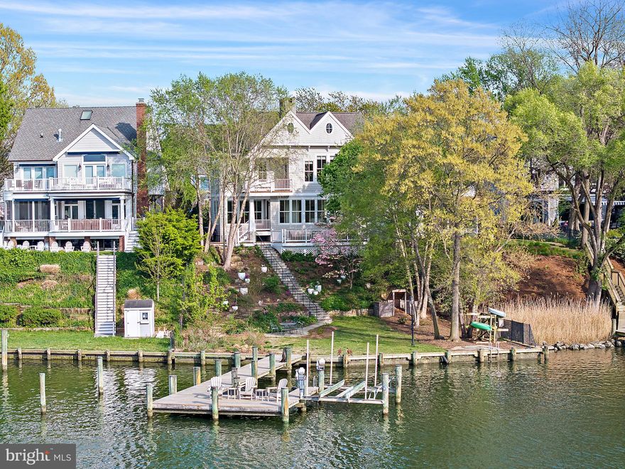 An exceptional waterfront residence on Spa Creek, The Spa Creek House is a custom home designed by Alt Breeding Schwarz Architects with a landscape plan by Forested Creative Ecology. Set on a prominent .165-acre site once part of a historic city park, this property offers approximately 4,250 square feet of finished living space thoughtfully designed to capture sweeping creek views.
The exterior showcases cedar shake siding, Azek trim, Marvin aluminum-clad windows, a 30-year architectural shingle roof, and a 2-car garage with designer doors. Modern amenities include public water and sewer, natural gas, electric car charger, whole-house surge protection, owned solar panels, generator, and a robust 400-amp electrical service.
Enjoy approximately 76 feet of bulkheaded waterfront with a resurfaced pier offering 6+ feet of water depth, a 10,000-pound boat lift, electric and plumbing at the dock, kayak storage, and lounge netting. A stone wall built from original Main Street cobblestones adds historic character at the water’s edge.
Inside, the home features a dramatic two-story entry, white oak hardwood floors, custom millwork, three gas fireplaces, built-ins, and an open layout ideal for both daily living and entertaining. The gourmet kitchen is equipped with Wolf, Sub-Zero, and KitchenAid appliances, granite countertops, and custom Mouser cabinetry. Four/five bedrooms and four baths include a main-level bedroom, an expansive primary suite with spa-like bath, upper-level laundry, and a finished lower level with bedroom/office, full bath, library shelving, and custom bar.
Outdoor living is enhanced by Massaranduba decking, a bluestone patio overlooking Spa Creek, and a low-maintenance permaculture landscape installed in 2023 featuring fruit trees, berries, herbs, and native plantings. Additional highlights include a fenced yard, irrigation system, exterior lighting, security system, and private driveway with pavers.
A rare opportunity to own a distinctive, energy-efficient waterfront home just minutes from downtown Annapolis, offering deep water access, refined craftsmanship, and unparalleled Eastport waterfront living.