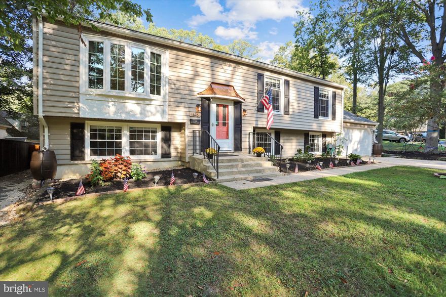Welcome Home to this terrific split-level  in the beautiful E Section of the highly sought after Crofton Triangle! Beautiful renovated kitchen! If you like to cook, bake, or entertain, this is the kitchen island of your dreams! Brand new entryway staircase with hardwoods and gorgeous new railings! Entertain or relax on the back deck with brand new Trex decking! Hardwood floors throughout the main living area. The upper level offers three bedrooms, including the primary bedroom with full bathroom. The lower level has a wonderful floor plan with two bedrooms and full bath private from the living space, a mudroom off the two car garage, and a spacious laundry room! Spacious and flat fully fenced backyard with beautiful new wood fence and entry gates on both sides of the home. Rain barrels connected to all downspouts--perfect for watering plants and yard. Crofton Elementary/Crofton Middle/Crofton High School! Join the Crofton and Swim and Tennis or Country Club! Ideally situated to provide easy access to all commuter routes! Waugh Chapel shopping center located right across Rt 3!