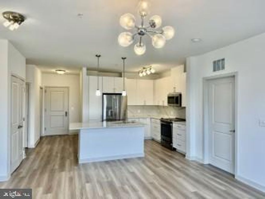 $500 GIFT CARD TO NEW TENANT IF LEASE IS SIGNED BY DECEMBER 31, 2025!!! HAPPY HOLIDAYS! Discover an unparalleled lifestyle in this exquisite 2-bedroom, 2-bathroom apartment nestled within the prestigious Boulevard VI Towns. Built in 2022, this luxurious residence boasts an open floor plan that seamlessly blends the kitchen and living areas, perfect for entertaining or relaxing in style. The gourmet kitchen features upgraded countertops, a spacious island, and energy-efficient stainless steel appliances, ensuring culinary excellence at every turn. Indulge in the spa-like master suite, complete with a walk-in shower and generous walk-in closet, providing both comfort and convenience. Elegant wood floors and recessed lighting enhance the sophisticated ambiance throughout the home, while the convenience of an in-unit washer and dryer adds to the modern living experience. Step outside to enjoy the community's resort-style amenities, including a sparkling pool, fitness center, and clubhouse, all designed for your leisure and enjoyment. The beautifully landscaped grounds feature BBQ grills and inviting sidewalks, perfect for evening strolls. With two assigned parking spaces in a secure garage and a prime location, this property offers both luxury and practicality.