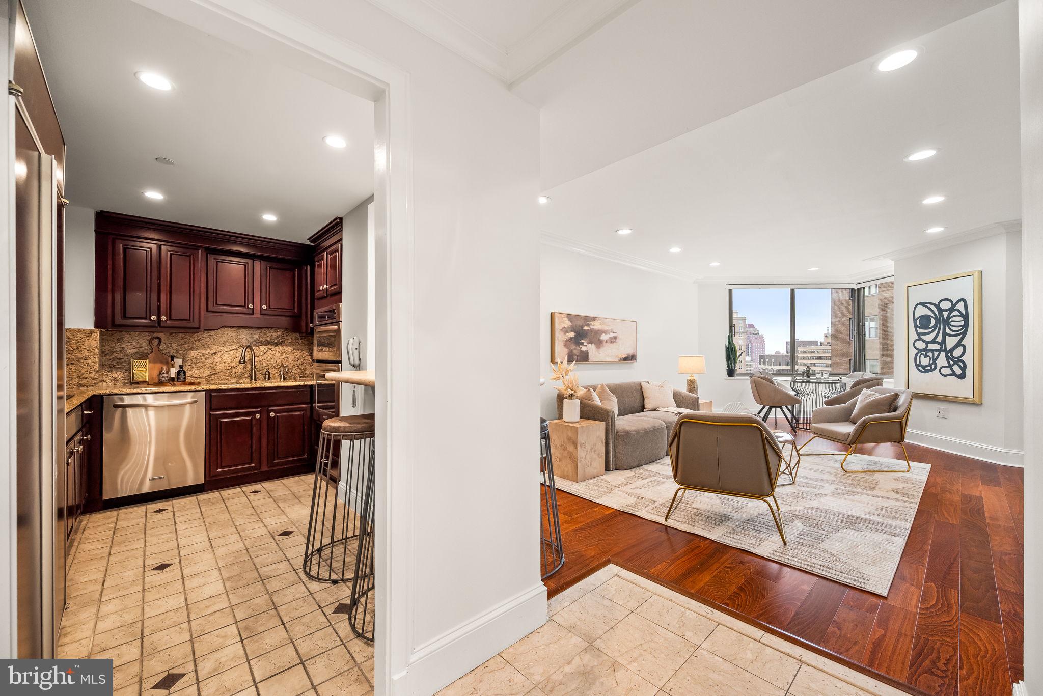 Experience the pinnacle of refined city living in this elegant 2 bedroom, 2.5 bath residence at the iconic Rittenhouse Hotel, situated on Rittenhouse Square. This rare offering showcases spectacular Park views from every window and seamless access to five-star hotel amenities, blending privacy with premier service. A wide, welcoming entry introduces a thoughtfully designed layout. The expansive living room features rich hardwood floors, recessed lighting, and French doors that provide flexibility to use the adjoining second bedroom as a den, office, or guest space. The gourmet kitchen is outfitted with cherry cabinetry, paneled refrigerator, an oven and microwave/convection oven, dual sinks, and a breakfast bar ideal for casual dining or entertaining. Both bedrooms are ensuite and generously sized. The primary suite includes a serene sitting area with views of the Square, a custom oversized walk-in closet, and a spa-like bath with dual vanities, jacuzzi tub, separate shower, and a laundry closet. The second bedroom easily accommodates both a sleeping and work area. Residents of The Rittenhouse enjoy access to an exceptional suite of services, 24-hour concierge, room service, housekeeping & laundry, Chauffeur-driven Mercedes sedan, Health club, indoor pool, steam room & sauna (membership required), Paul Labrecque Salon & Spa, On-site dining at Lacroix, Scarpetta, and The Library Bar. Valet parking is available for a monthly fee. Just outside your door, enjoy the vibrant culture and serenity of Rittenhouse Square, surrounded by Philadelphia’s finest restaurants, boutiques, and cultural attractions. Whether enjoying a morning stroll through the park, an evening at a top-tier restaurant, or the tranquility of your private residence above it all, this home is a rare find that perfectly balances luxury, location, and lifestyle.