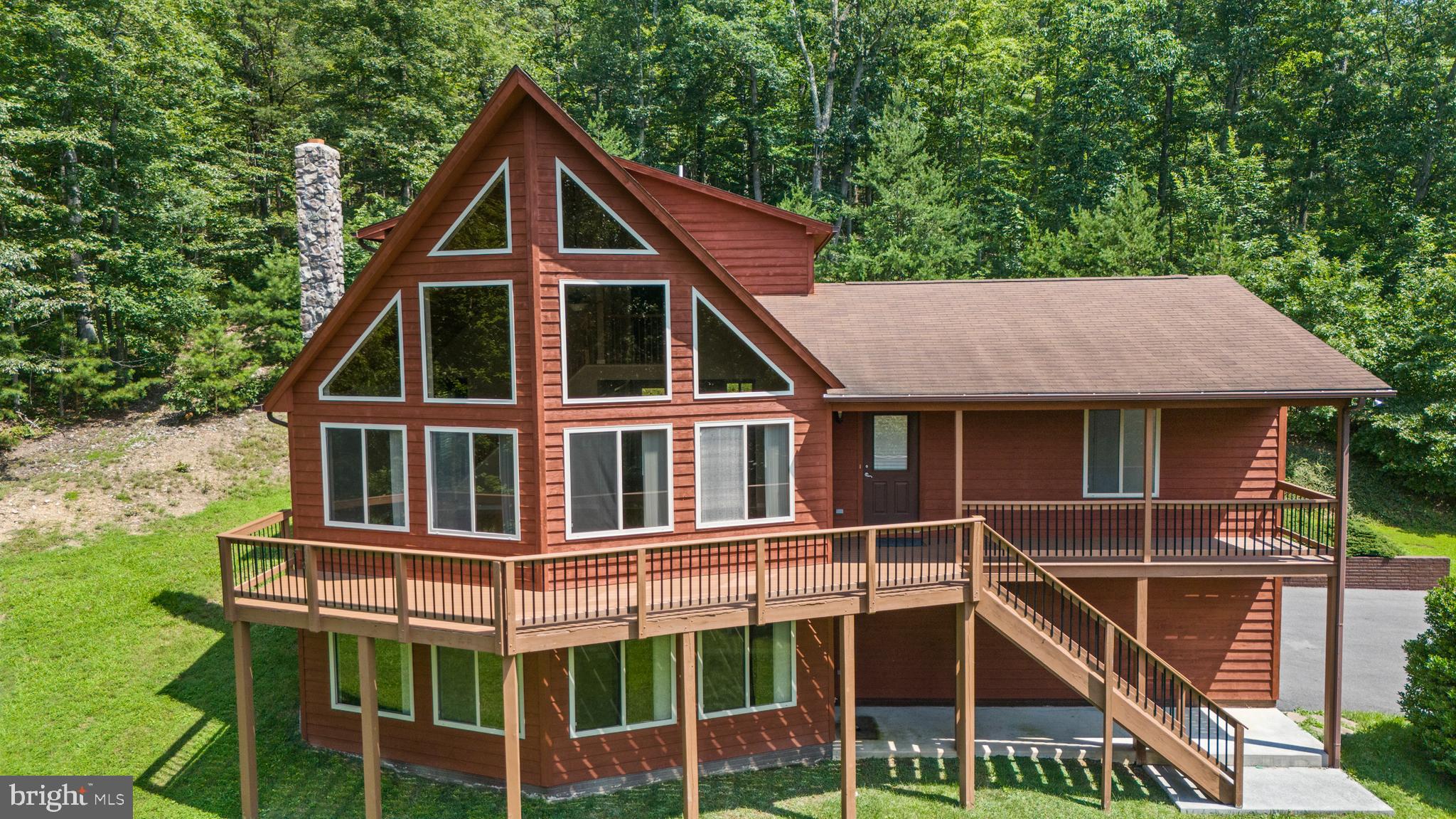Tranquil Chalet Living Just Minutes from Town and Interstate 66! Enjoy peaceful living in this beautifully maintained chalet, nestled on a private 5-acre lot—just five minutes from the Town of Front Royal and I-66. This charming home offers 3 bedrooms and 3 full baths, a finished basement, along with freshly stained siding, newly installed carpeting in all bedrooms, and refinished hardwood floors throughout the main living areas. Recent interior updates include fresh paint in the family room, kitchen, dining room, main floor bathroom, hallway, and the primary suite—creating a clean, move-in ready space. Step out onto the front deck to take in stunning wooded and mountain views, or explore the established trails that wind through your very own 5-acre retreat.
Looking for more room to roam? The adjacent 5-acre parcel is also available for purchase, offering added privacy and even more potential for outdoor adventures. Recent upgrades include: New HVAC system (2020), new dishwasher (2022), new well pump (2023), new septic tank pump and floats (2023), new hot water heater (2024). This is a rare opportunity to own an updated, nature-surrounded home with easy access to town conveniences—don’t miss your chance!