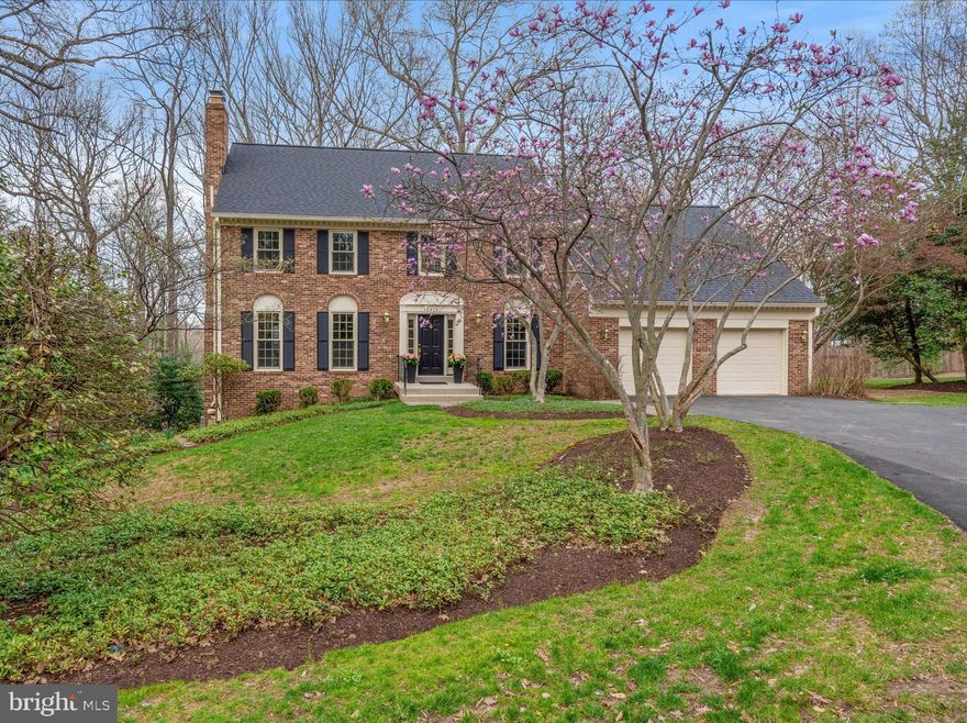 Tucked away at the end of a peaceful, tree-lined street in the sought-after Colvin Run Estates, this stunning Center Hall Colonial sits within an enclave of 27 homes on quiet streets, offering unparalleled access to trails and parks. With a commanding presence and timeless elegance, the home has been lovingly maintained by its original owners and thoughtfully updated for modern living.

Step inside to a freshly painted interior that enhances the home’s original charm, while newly refinished hardwood floors add sophistication. The spacious layout is designed for both everyday living and entertaining, featuring large, light-filled rooms that flow effortlessly.

A gracious foyer welcomes you with two coat closets and gleaming hardwood floors, leading to an elegant living room with a wood-burning fireplace and custom mantel. The formal dining room, bathed in natural light, overlooks the private backyard and features custom molding and a classic brass chandelier. The main level also includes a private office or den, a centrally positioned powder room, and an inviting family room with a wood-beamed ceiling, impressive stone fireplace, and sliding glass doors that open to the expansive deck. The eat-in kitchen is well-appointed with cherry cabinetry, granite countertops, updated stainless-steel appliances, two pantry closets, and double French sliding doors leading to outdoor living space. A convenient garage entrance is located just off the family room.

Upstairs, the primary suite serves as a tranquil retreat with a spacious sitting area, walls of closets—including a large walk-in—and a beautifully updated en-suite bath featuring a double vanity with quartz countertops and an oversized walk-in shower with custom tile. Three additional bedrooms offer generous space, natural light, and ample closets.  A full hallway bathroom with a tub-shower combination serves these rooms, while a dedicated laundry room with built-in cabinetry adds convenience. Two linen closets provide extra storage.

The lower level offers endless possibilities, with a private fifth bedroom, a large walk-in closet, and a cozy brick fireplace anchoring the entertainment area. A wet bar with a sink and new mini-refrigerator makes it perfect for movie or game nights. A full bathroom on this level is ideal for guests or multi-generational living. Abundant storage, multiple closets, and a spacious utility room enhance functionality. Sliding glass doors lead to a slate patio and private backyard, seamlessly blending indoor and outdoor spaces.

Set on 1.056 acres, the home’s exterior is equally impressive. A charming brick walkway leads to the inviting front entrance, while tasteful landscaping adds to its curb appeal. The expansive rear deck offers stunning views of mature trees and protected parkland near Difficult Run and the Cross County Trails.  The recently replaced roof provides added peace of mind.

Beyond its natural beauty, this home offers unbeatable convenience. Ideally located just minutes from Vienna, Reston, Great Falls, and Tysons,  providing easy access to premier dining, shopping, and entertainment. Major commuter routes, including Route 7, the Dulles Toll Road, and I-495, are all within close reach, making travel throughout the region effortless. For those who commute into D.C. or surrounding areas, nearby Metro stations and Dulles International Airport provide additional transportation options.

Additional highlights include newly refinished hardwood floors, fresh neutral-toned paint, new carpeting in all upper-level bedrooms, custom molding and trim, and newer Andersen and Marvin windows and sliding glass doors for improved efficiency and aesthetics. Three wood-burning fireplaces add warmth and character throughout the home, making this an exceptional place to call home!