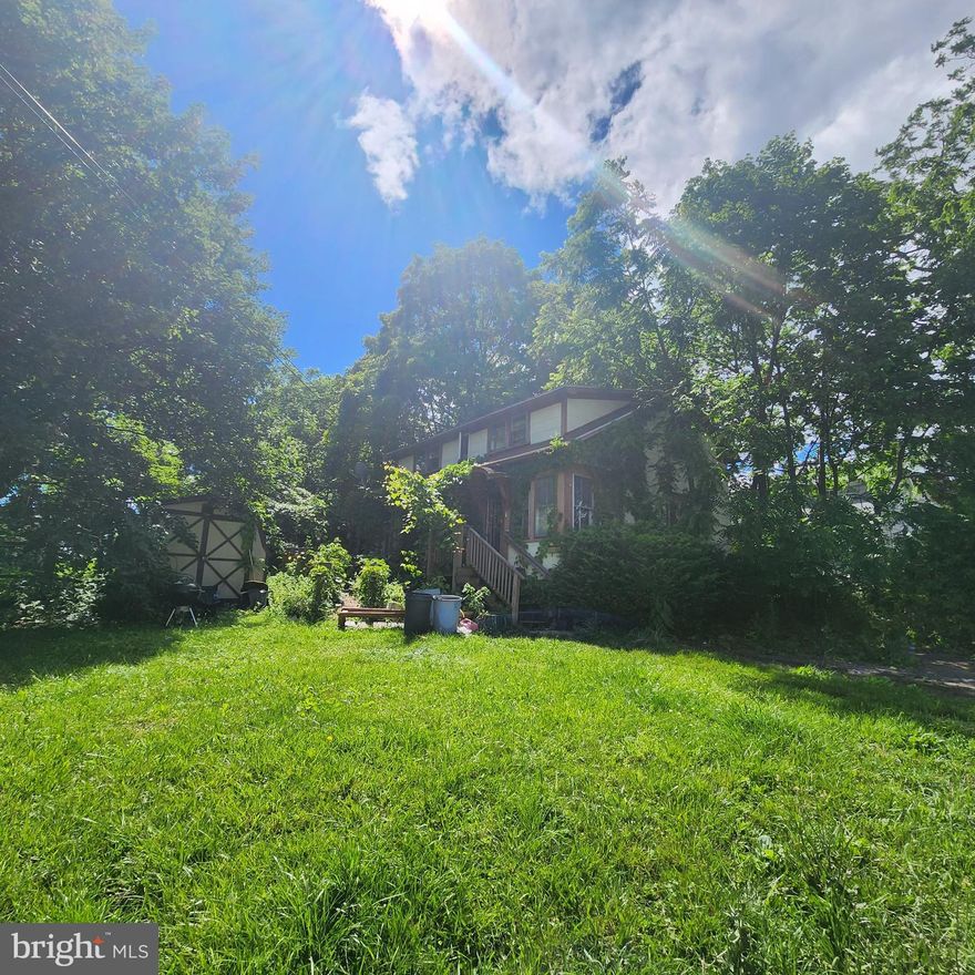 Large lot, house sold as-is.