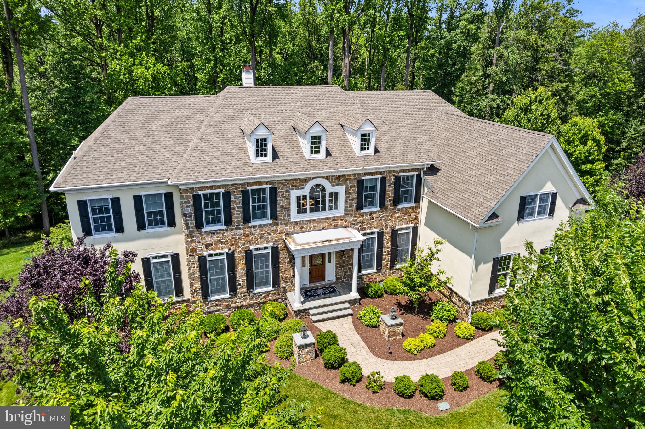 Welcome to an extraordinary residence in the most sought-after Liseter community in Newtown Square—where timeless architecture meets modern sophistication. Ideally situated at the end of a quiet cul-de-sac and on a premier lot backing to the tranquil Newtown Meadow Reserve, this distinguished home features an expansive layout with finely crafted living spaces, all surrounded by 50 acres of preserved open space—offering unparalleled privacy and natural beauty.
Designed for luxurious everyday living and elegant entertaining, the home features five generously appointed ensuite bedrooms on the upper level and three additional bedrooms on the lower level, perfect for extended family or private guest accommodations. The primary suite is a private retreat, offering a serene sitting room and three custom walk-in closets for ultimate organization.
At the heart of the home is a dramatic two-story great room, extended eight additional feet to create a magnificent gathering space flooded with natural light. The formal living room and gracious dining room provide classic spaces ideal for refined entertaining and family gatherings. A large gourmet kitchen is the true centerpiece, featuring high-end appliances, two dual beverage refrigerators, a dedicated serving area, and a sunroom that invites morning coffee with peaceful garden views. A handsome bonus room on the main level offers flexibility for a library, executive office, music room, or playroom.
The fully finished lower level is designed for both relaxation and recreation, boasting a custom home theater, full wet bar with dual refrigerators, and a dedicated fitness studio.
Refined architectural details include a grand butterfly staircase, custom coffered ceilings, rich wood beams, and handcrafted millwork throughout. A second staircase from the kitchen offers easy access to the upper level, while a built-in AV system and Control4 smart home automation provide modern convenience discreetly woven into the home’s classic design. For year-round comfort, the residence is equipped with three HVAC systems, each servicing a separate level.
Outdoors, the home is equally impressive with a two-level deck complete with outdoor speakers, a gracious paver patio off the lower level, and professional landscaping enhanced by a full irrigation system. A stately hardscape front walkway and expanded entry create an elegant approach to the home.
Living in the Liseter community is like having your own private country club, featuring exclusive amenities such as a sparkling community pool, a fully equipped gym, multiple sports courts, and scenic walking trails. The stunning community barn serves as a perfect venue for gatherings and entertaining. Ideally located, this neighborhood offers effortless access to Center City Philadelphia, convenient Amtrak service to New York from nearby Paoli, and easy trips to the New Jersey beaches. Discover the perfect balance of refined town living and serene country charm in this exceptional community.
Rarely does a property of this caliber and location become available. Offering timeless appeal, modern amenities, and an unmatched setting, this is truly a legacy home to be treasured for generations.