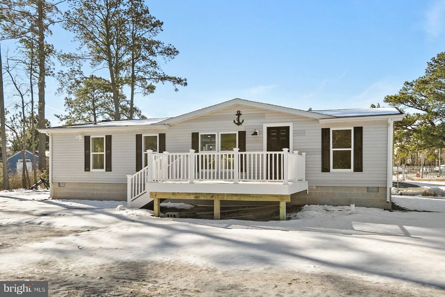 Welcome to this completely renovated, like-new ranch home, thoughtfully updated from top to bottom and ideally situated at the end of a quiet non-through street on a spacious lot. With no HOA and no lot rent, this custom three bedroom, two bath residence offers the freedom, privacy, and convenience today’s buyers are looking for, all in very close proximity to the Indian River Bay.

From the moment you arrive, the home’s fresh exterior and custom front deck set an inviting tone. Step inside to discover a bright, open floor plan where vaulted ceilings enhance the sense of space and light. The living room flows seamlessly into the dining area and kitchen, creating a welcoming layout perfect for everyday living and entertaining. New flooring, interior doors with sleek black hardware, and fresh paint throughout give the home a crisp, modern feel.

The kitchen has been beautifully redesigned with upgraded quartz countertops, all new cabinetry, a stylish sink and fixtures, and select stainless steel appliances. Recessed lighting, display shelving, and an L shaped breakfast bar add both function and character, while a cozy breakfast nook framed by large windows provides a sunny spot to start your day. Crown molding throughout the main living spaces adds a refined finishing touch.

Both bathrooms have been completely renovated with spa inspired details. The primary suite is a true retreat, featuring a spacious walk in closet and a luxurious en suite bath with a dual vanity, an extra wide tiled shower with rain showerhead, and a modern vanity mirror with built in lighting and defrost features. Two additional bedrooms offer brand new carpeting and share a well appointed hall bath with a tub and shower combination.

Behind the scenes, major upgrades provide peace of mind, including a new roof with updated sheathing and shingles, new windows, a new HVAC system, a new submersible well, and updated lighting throughout. Additional features include Ring spotlights and camera for added security, an oversized driveway constructed with rolled millings, and newly added topsoil and grass seed to refresh the landscape.

The seller is offering a generous landscaping budget with an acceptable offer, with potential credits toward privacy fencing or shrubbery, allowing you to personalize the outdoor space to suit your needs. Conveniently located near popular local amenities and coastal attractions, this home truly feels brand new and move in ready. Professional photos coming soon. This is a rare opportunity to own a beautifully updated ranch in a prime coastal location with no HOA restrictions.
Some photos have been virtually staged.